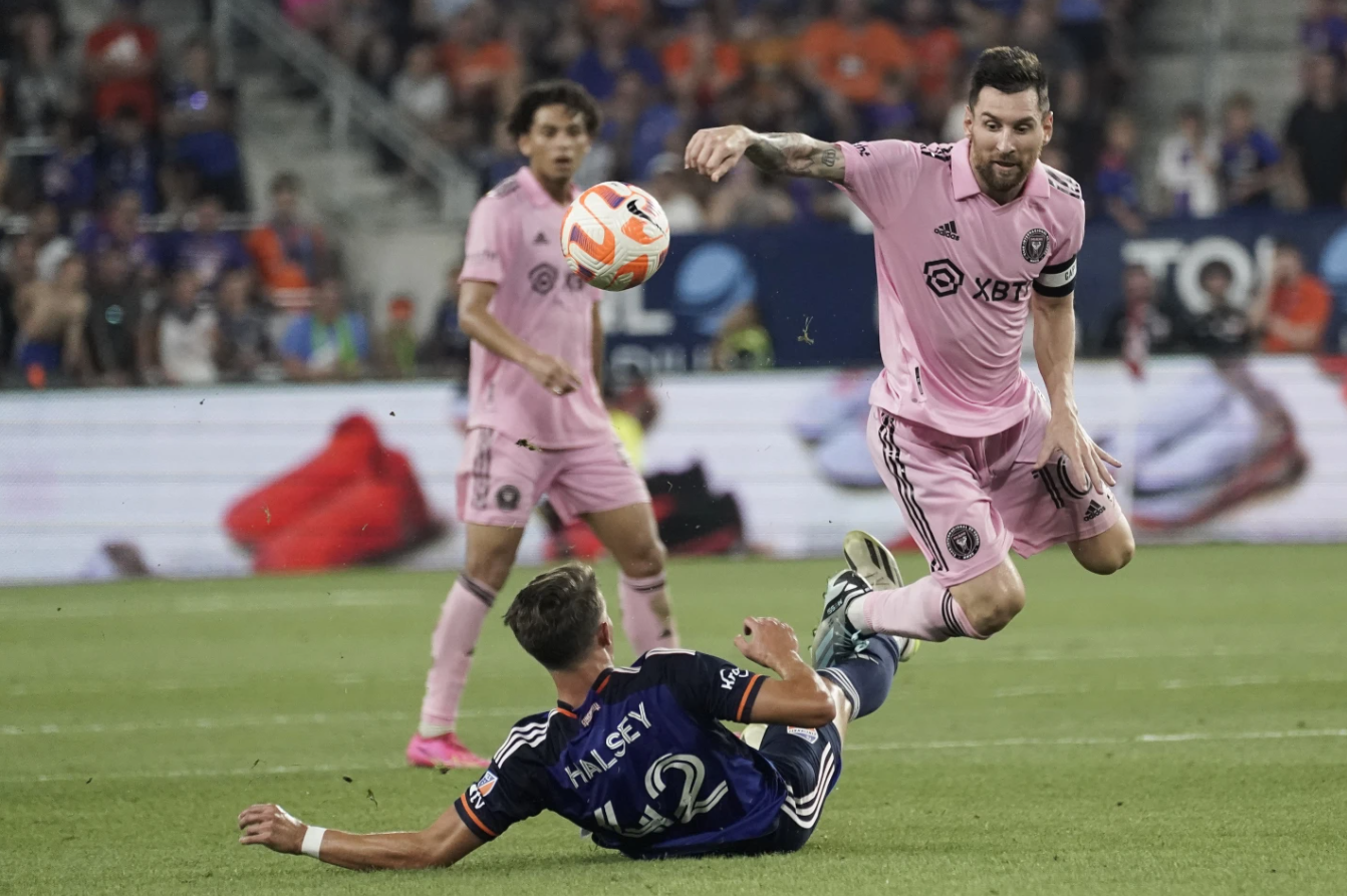 Inter Miami forward Lionel Messi, right, tries to avoid a tackle from FC Cincinnati defender Bret Halsey during the second half of a U.S. Open Cup soccer semifinal Wednesday, Aug. 23, in Cincinnati.