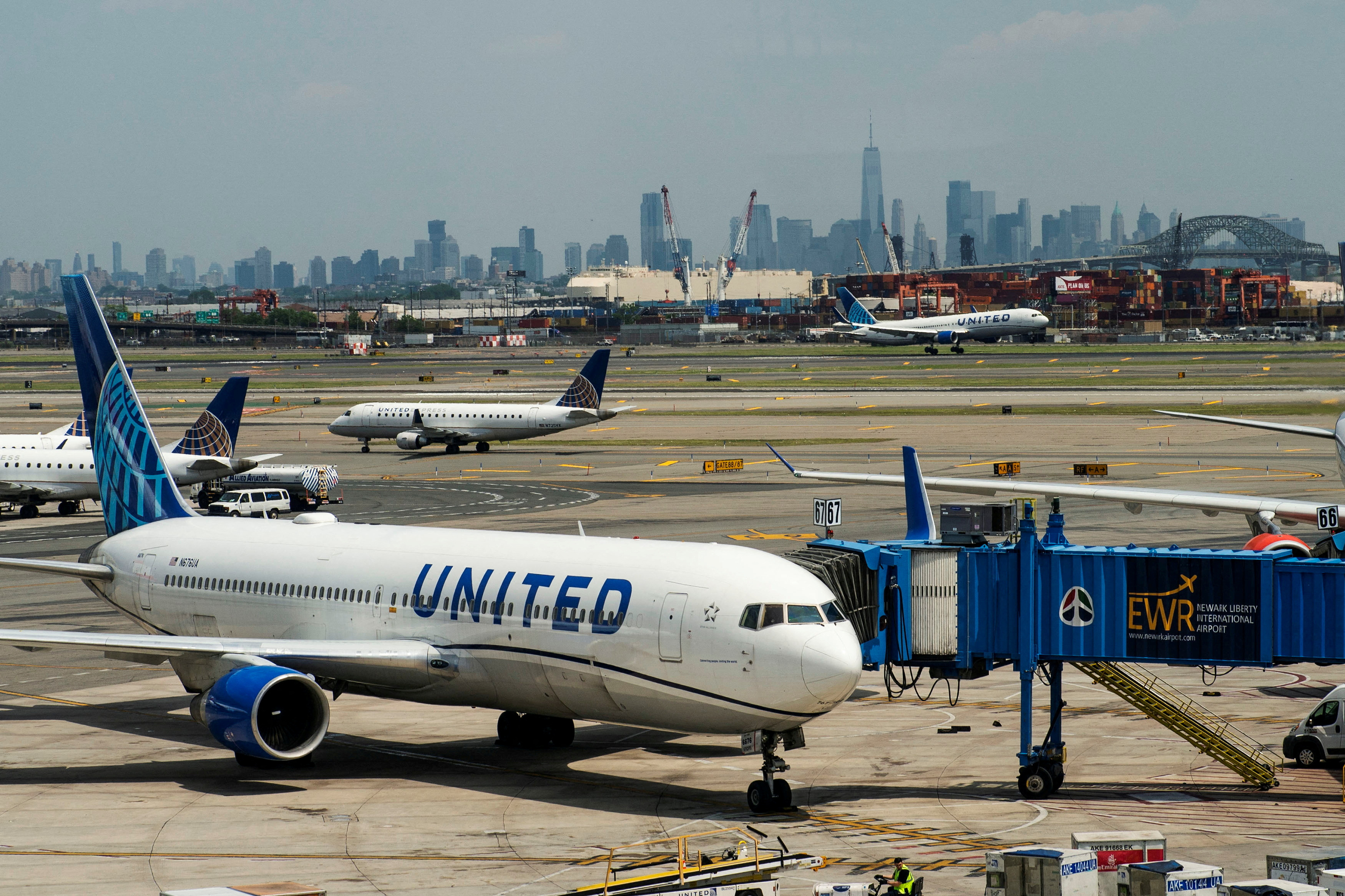 The One World trace Center and the New York skyline are seen while United Airlines planes use the tarmac as pilots from United Airlines take part in an informational picket at Newark Liberty International Airport in Newark, New Jersey, U.S., May 12, 2023. REUTERS/Eduardo Munoz/File Photo