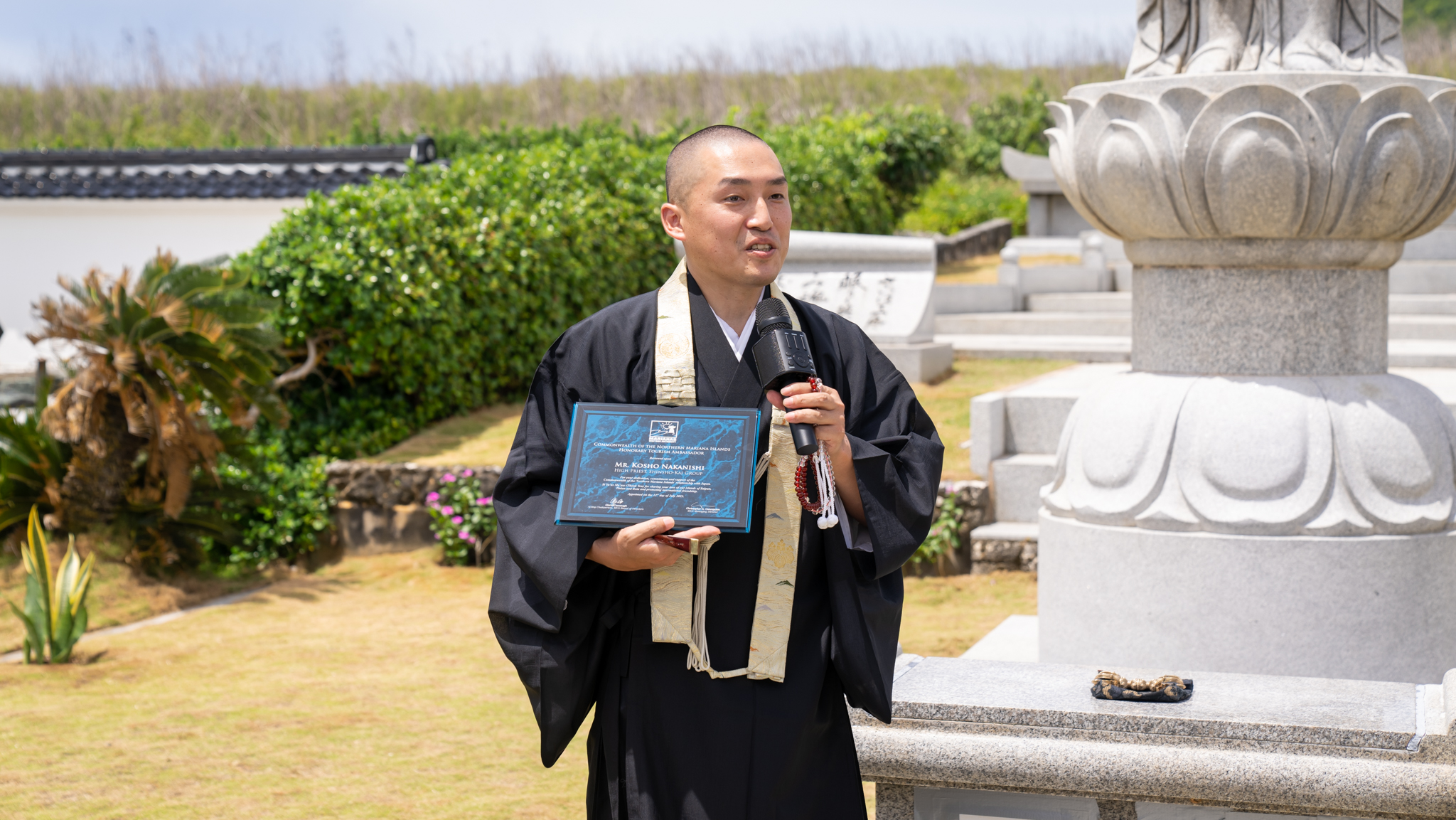 Shinsho-kai High Priest Kosho Nakanishi, left, is appointed Marianas tourism ambassador on July 22, 2023, by Marianas Visitors Authority Managing Director Christopher A. Concepcion at Banzai Cliff, Saipan.