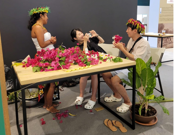 An interactive demonstration shows how to make indigenous Carolinian "mwar" (floral head lei) on July 20, 2023, at The Marianas Experience, a free interactive cultural experience open to the public on Tuesdays, Thursdays, and Saturdays at T Galleria in Garapan, Saipan.