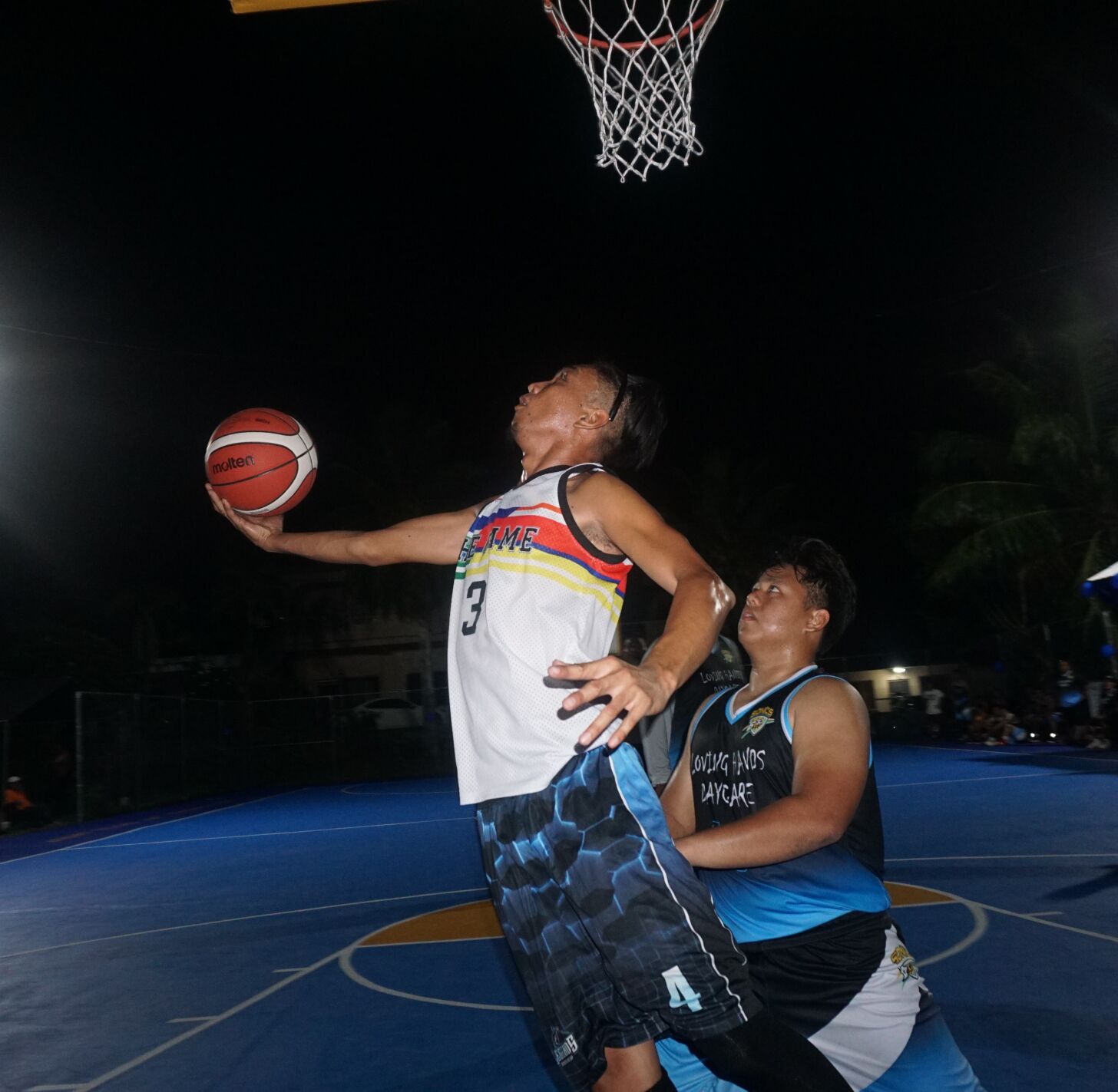 The Game's Jr Galang extends for the reverse finish during the opening game of the 2023 Saipan MagaLahi Eagles Club Invitational Basketball League at the Gualo Rai basketball court on Sunday.
