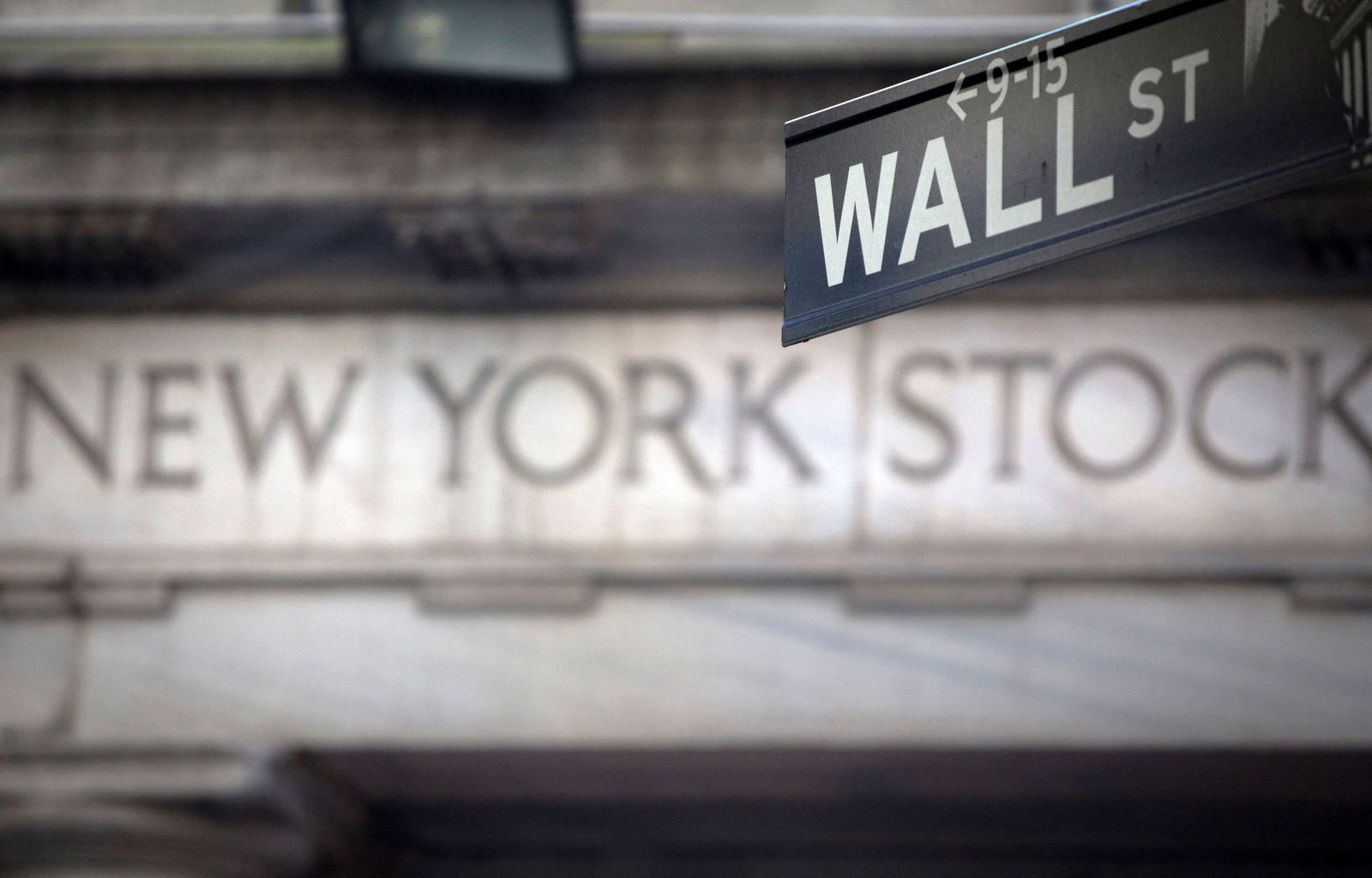 A Wall Street sign is pictured outside the New York Stock Exchange in New York, Oct. 8, 2013.