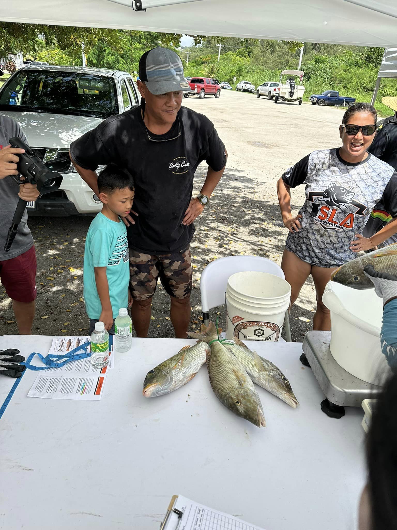 Nibbler captain Ed Diaz and his son, Edwardo Jr., look on as they weigh their catch in the biggest catch category of the 5th Annual Mafuti Derby of the I Sanhalom Laguna Anglers or ISLA Association at Smiling Cove Marina on Saturday.