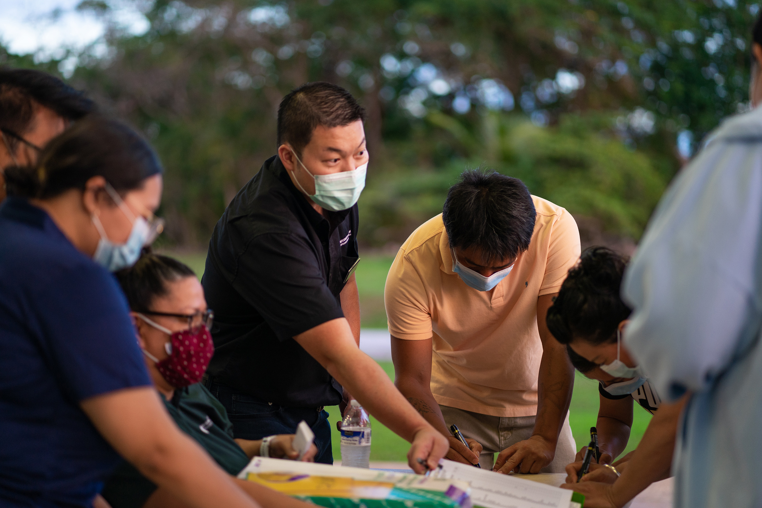 Dr. Kuan-Ju Chen, an agricultural economist at the University of Guam and lead of the Farmer Focus Project, hands out the agricultural stress surveys to local farmers in 2021.  