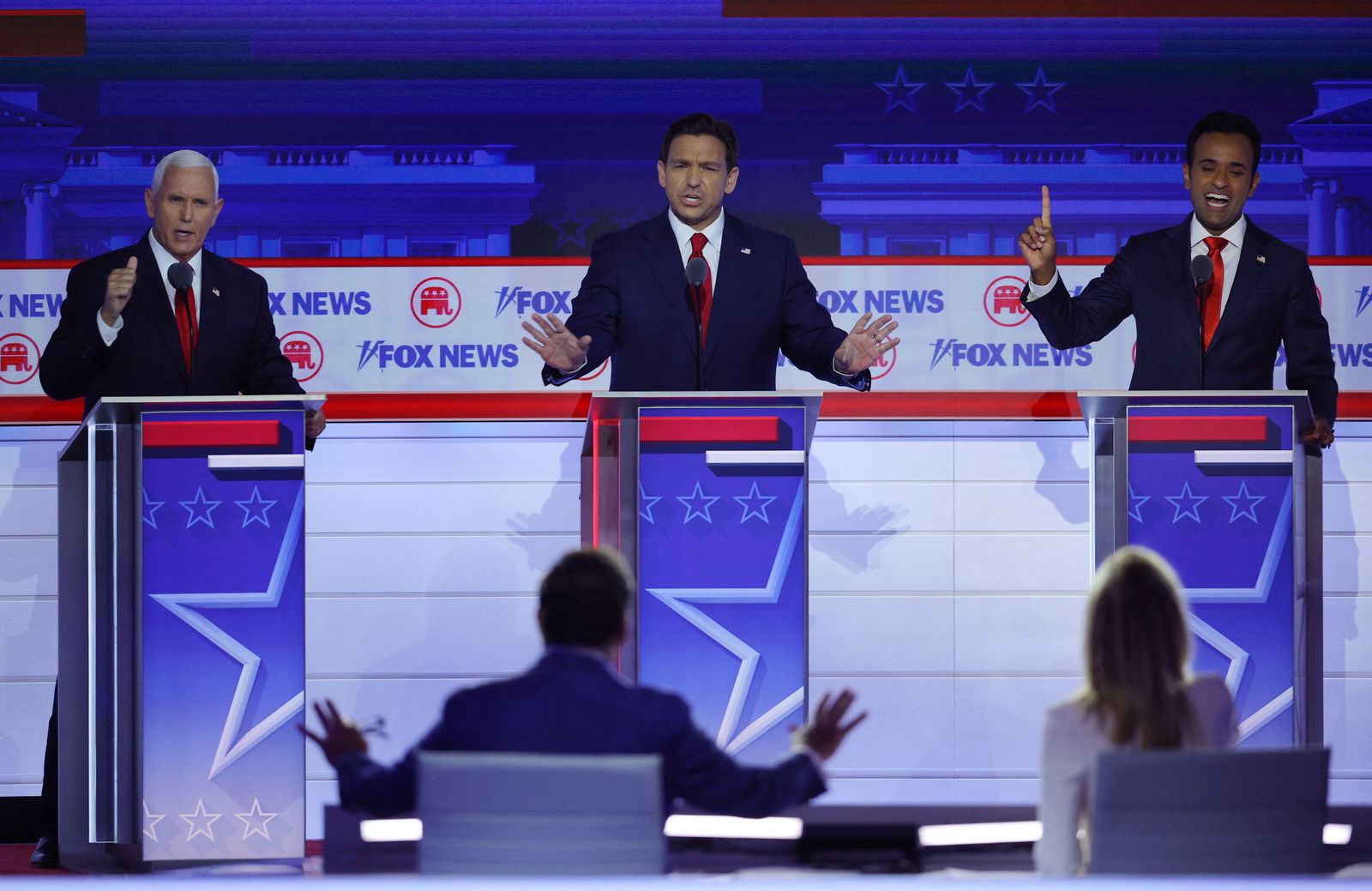 Former U.S. Vice President Mike Pence, Florida Governor Ron DeSantis and former biotech executive Vivek Ramaswamy all speak at the same time as debate moderator Brett Baier tries to referee at the first Republican candidates' debate of the 2024 U.S. presidential campaign in Milwaukee, Wisconsin, U.S. August 23, 2023. REUTERS/Brian Snyder