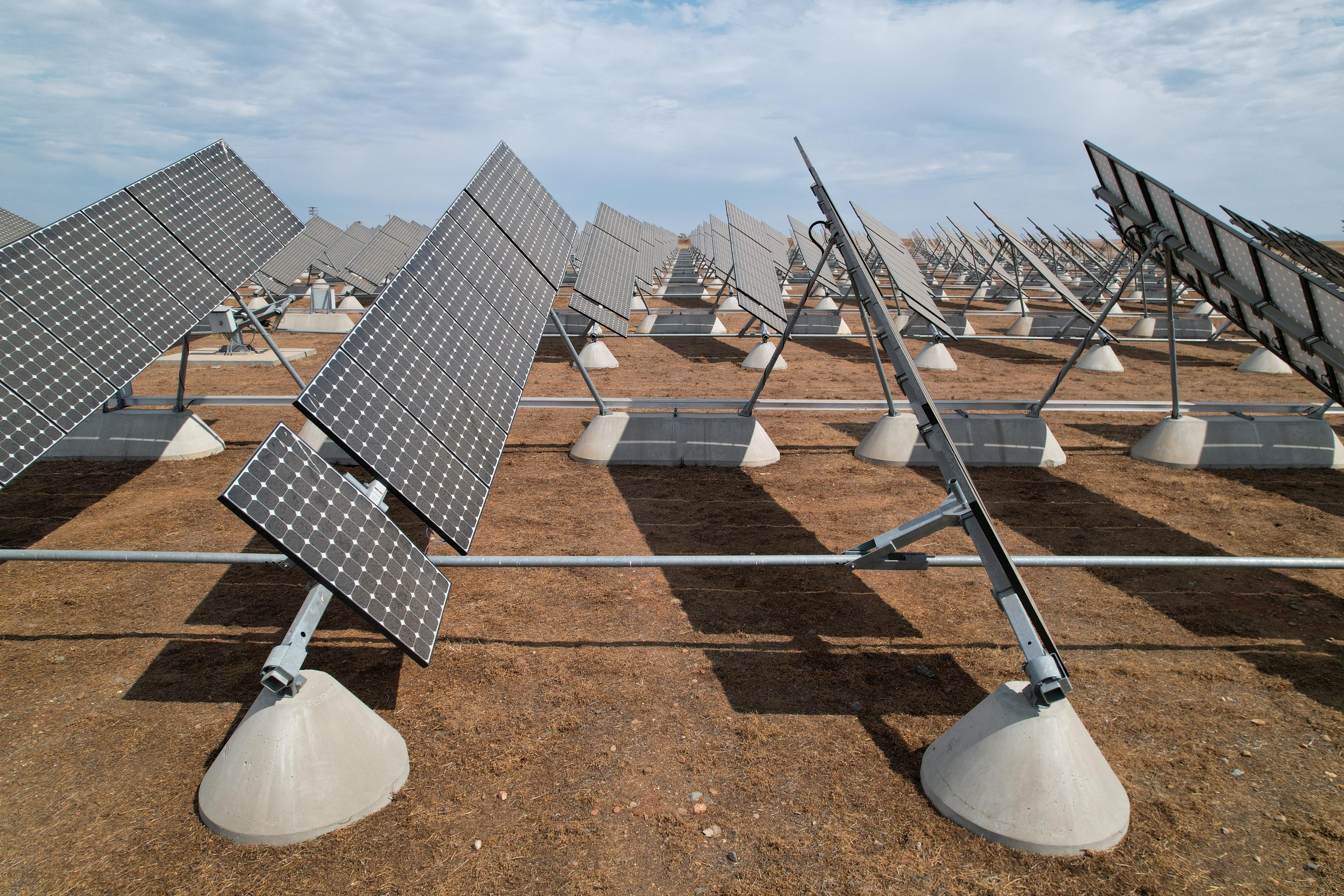 Solar panels are set up in the solar farm at the University of California, Merced, in Merced, California, U.S. August 17, 2022. REUTERS/Nathan Frandino/File Photo