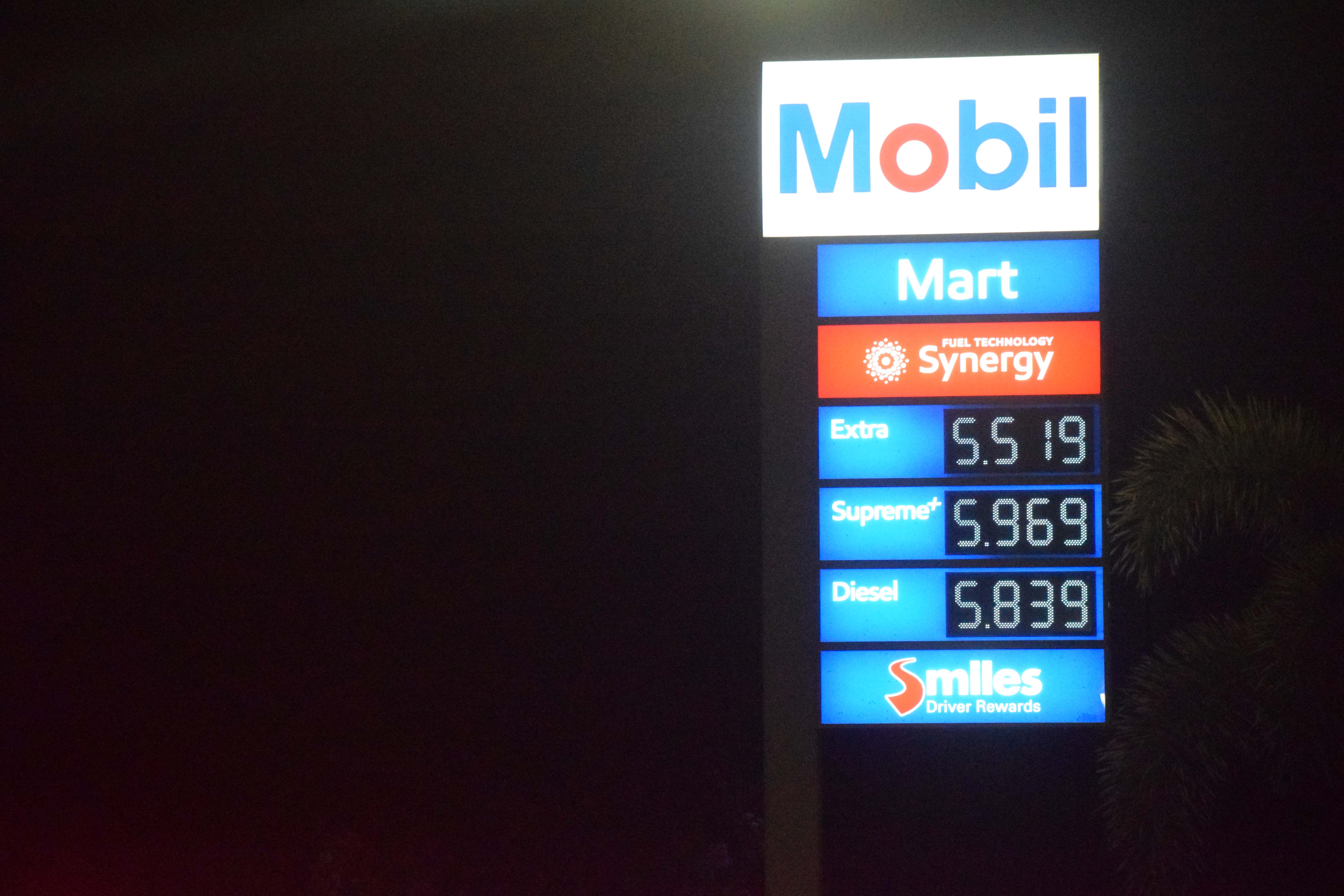 Mobil Oil Marianas in Tanapag displays its prices on Wednesday evening.