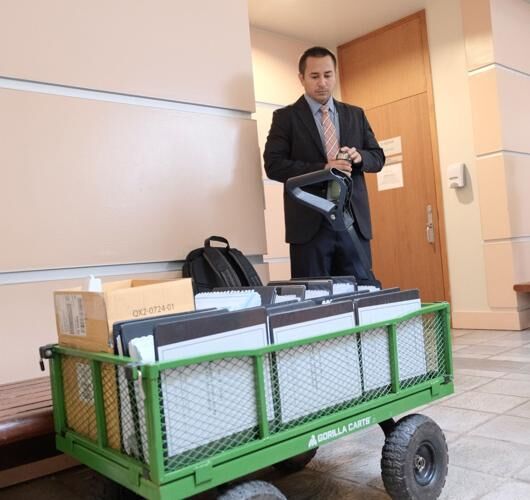 Christian Calvo, attorney for the Guam International Airport Authority, stands beside a wagon of documents before GIAA’s court case against DFS Guam at the Superior Court of Guam in Hagåtña on Wednesday, Aug. 2, 2023.