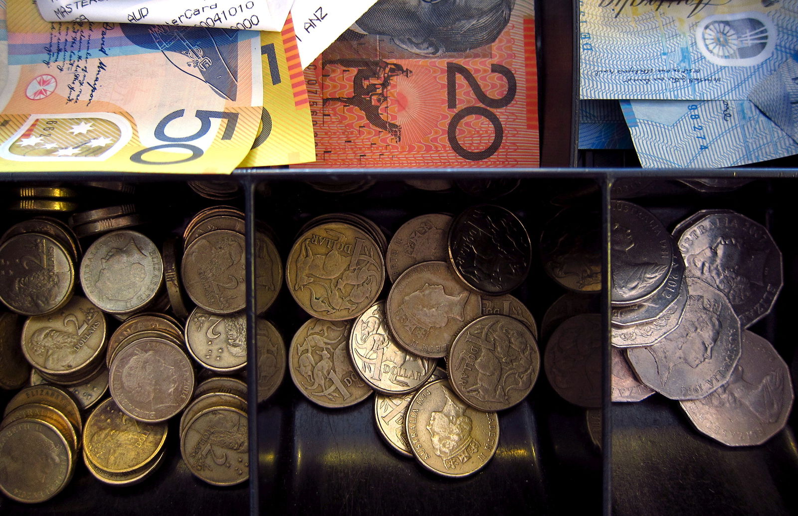 Australian dollar notes and coins can be seen in a cash register at a store in Sydney, Australia, Feb. 11, 2016.