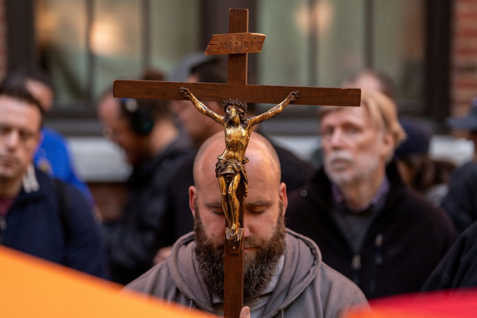 A friar holds a crucifix as he prays at Planned Parenthood during a monthly anti-abortion protest in New York City, U.S., May 6, 2023. REUTERS/David 'Dee' Delgado/File Photo