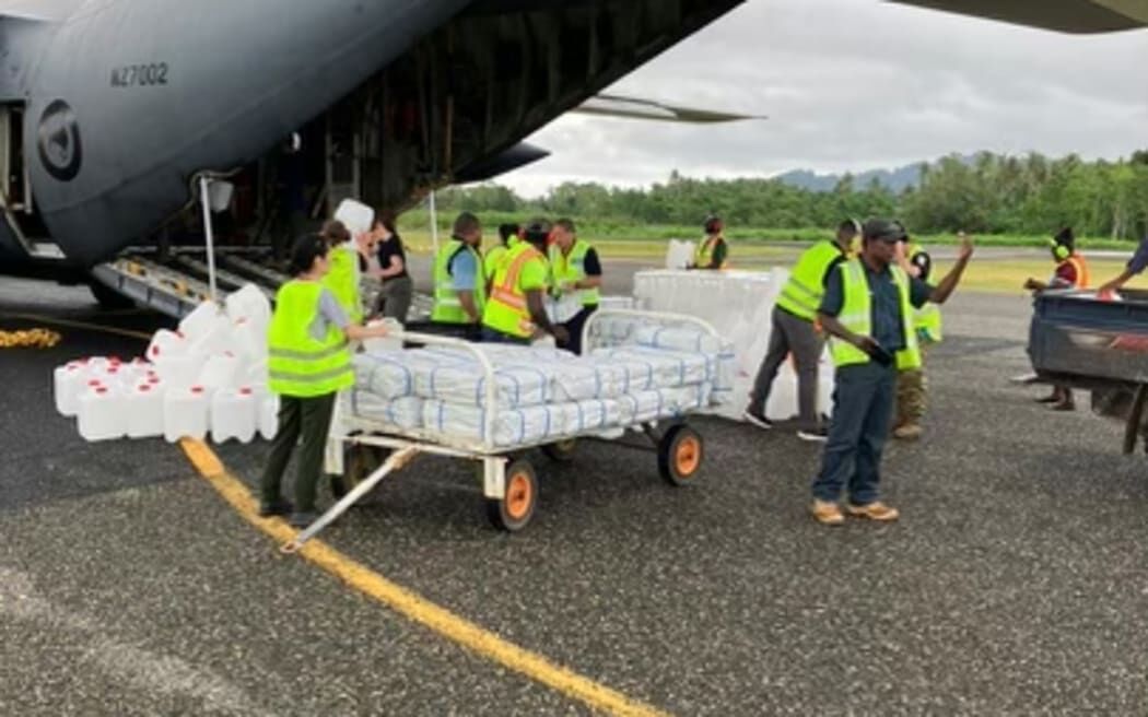 Supplies for communities affected by the ongoing eruption of Bougainville's Mt Bagana, are unloaded from an RNZAF C-130 Hercules. 