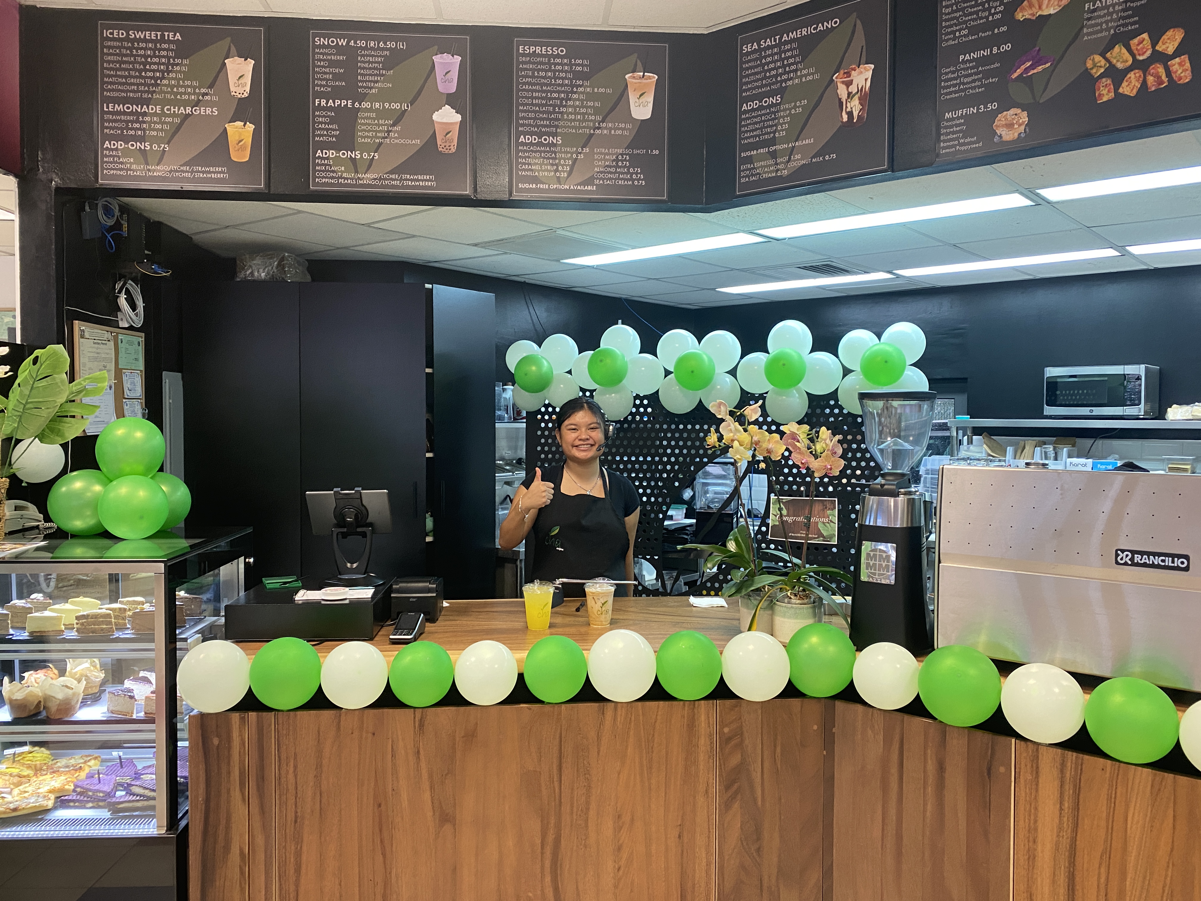 Tinalyn Litulumar, a cashier, poses with a Sea Salt Americano and a Lemonade Charger, which is exclusively offered at Cha Café’s new location at Mobil Middle Road Garapan.