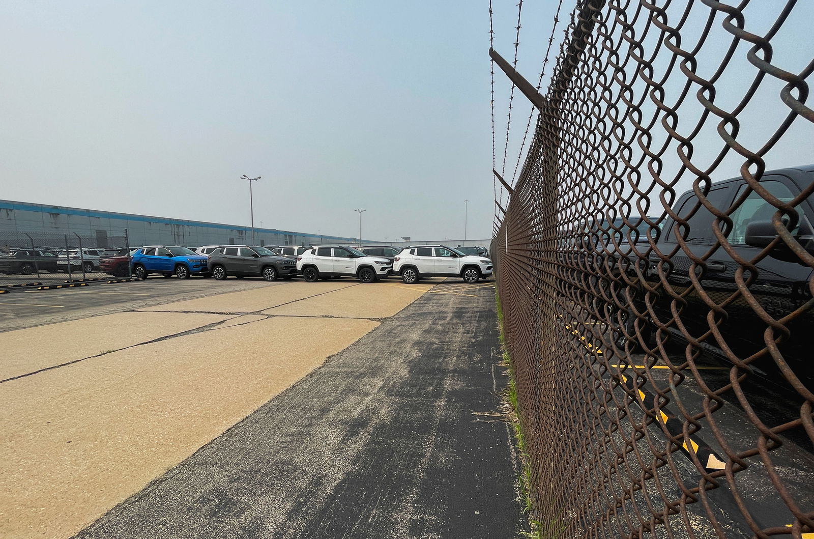 Jeep Cherokee SUV's and Ram trucks fill the parking lot at the Stellantis plant that was idled in February 2023, in Belvidere, Illinois, U.S., June 27, 2023. REUTERS/Bianca Flowers
