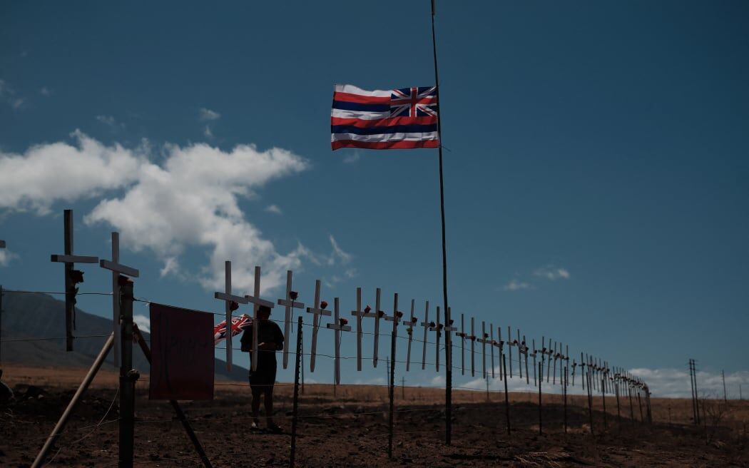 Crosses are attached by local residents to mourn the victims on a hill overlooking Lahaina, which has been devastated by wildfire.