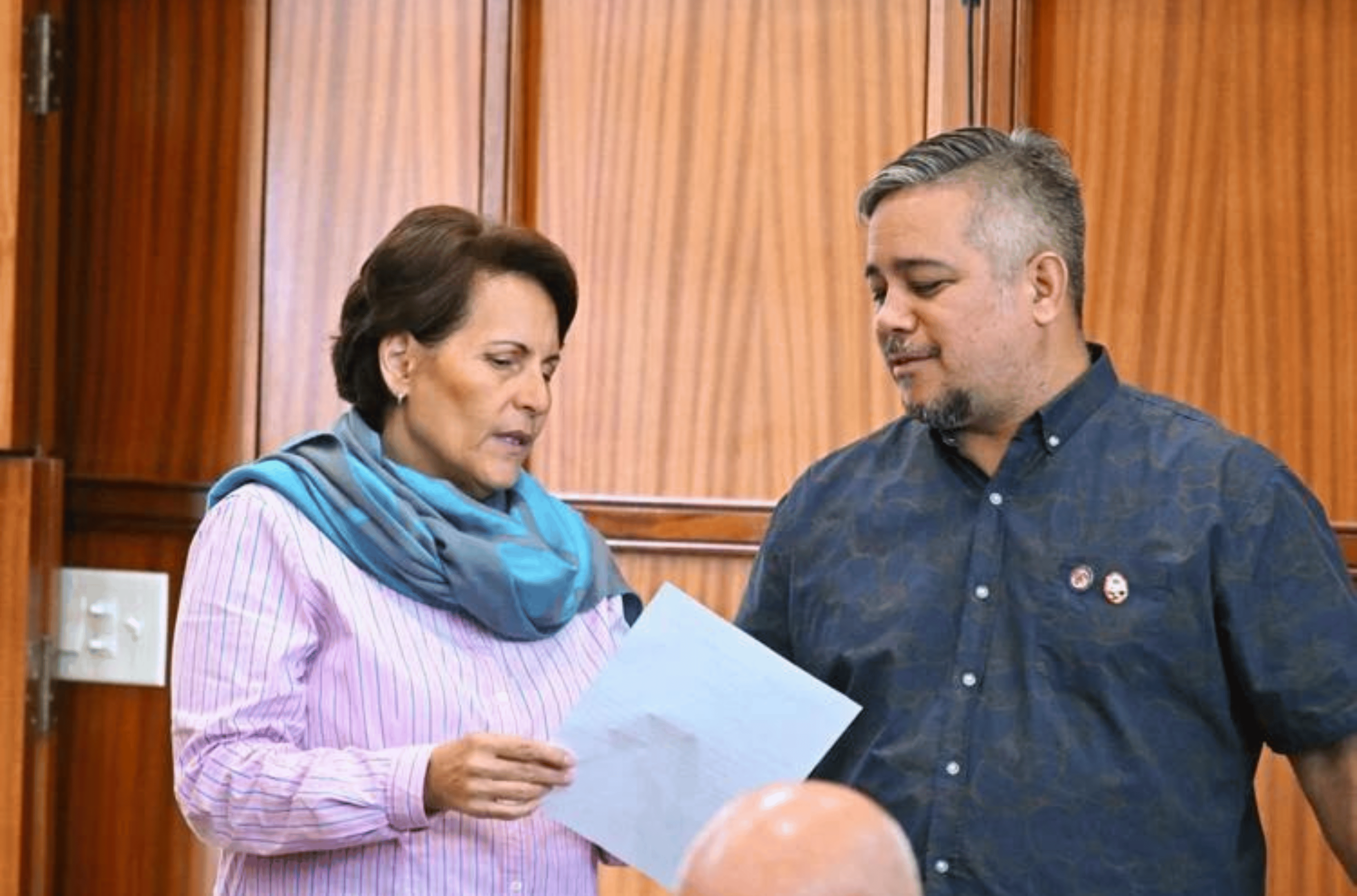 Sens. Telo Taitague, left, and Chris Barnett look over a document during legislative discussions on the fiscal year 2024 budget bill Thursday, Aug. 10, 2023.
