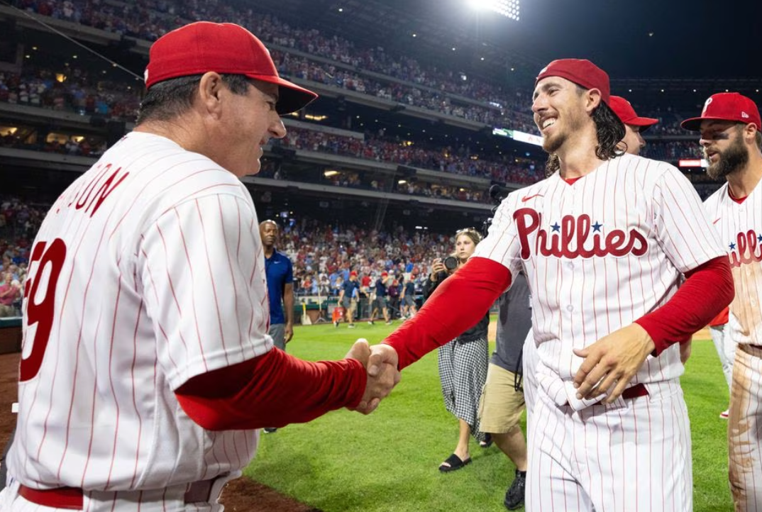 Philadelphia Phillies manager Rob Thomson, left, shakes hands with starting pitcher Michael Lorenzen, right, after his no hit victory against the Washington Nationals at Citizens Bank Park in Philadelphia, Pennsylvania, Aug. 9, 2023.