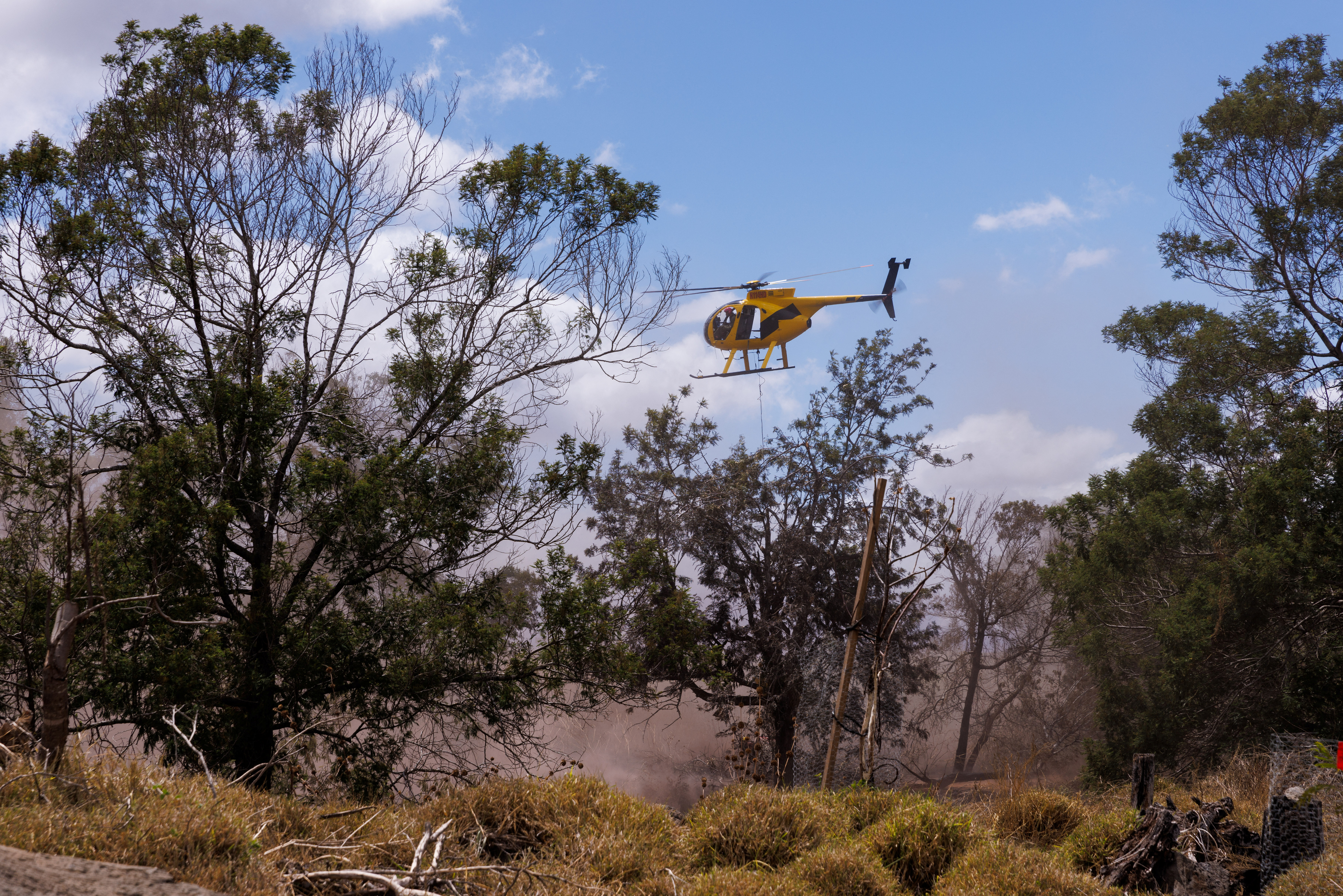 A firefighting helicopter helps fight flare-up fires in Kula, Maui island, Hawaii, U.S., August 13, 2023. REUTERS/Mike Blake