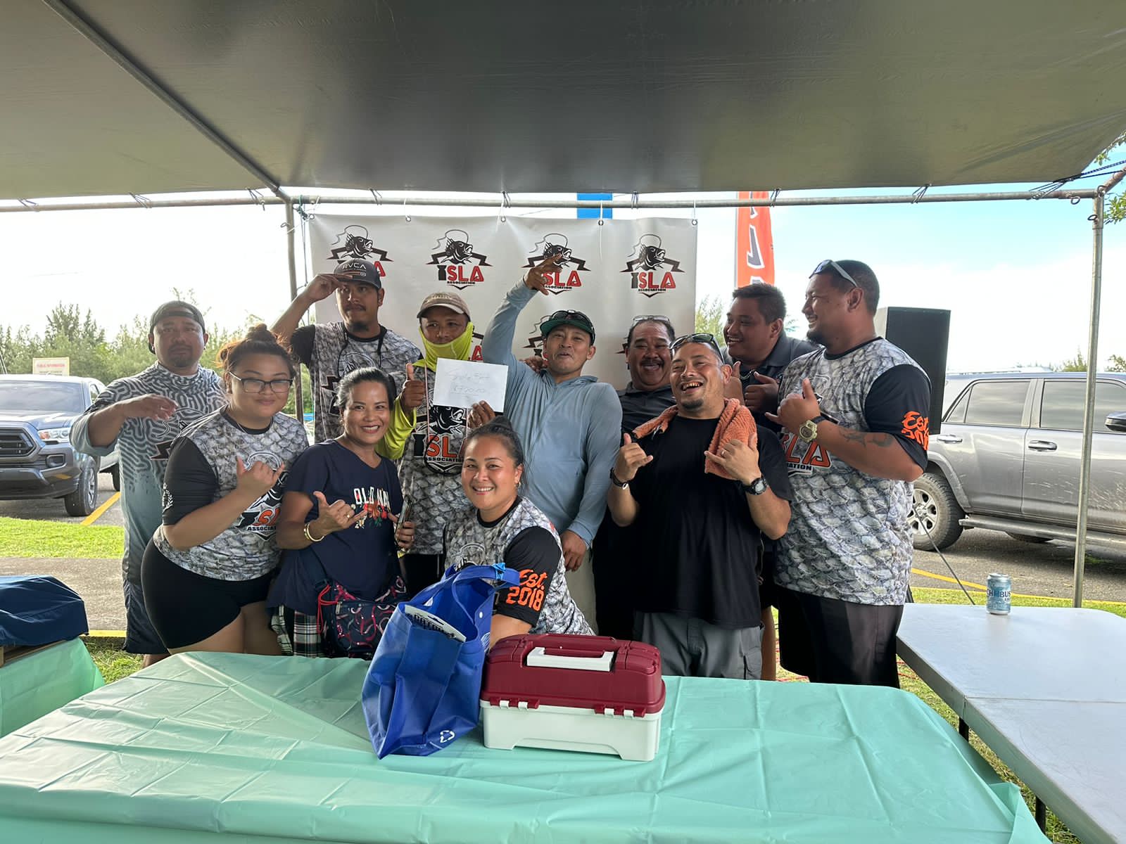 Frederic Guintu, captain of the Golden Green, which won the side bet, poses with I Sanhalom Laguna Anglers Association President Keith Kintol and board members during the awards ceremony of the 5th Annual ISLA Mafuti Derby Saturday at Smiling Cove Marina.