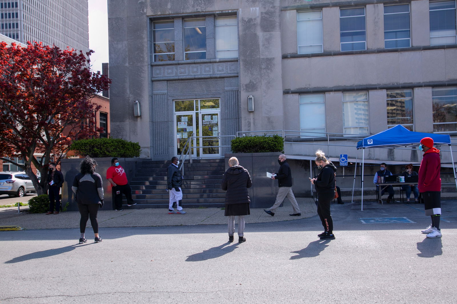 People queue outside a newly reopened career center for in-person appointments in Louisville, Kentucky, U.S., April 15, 2021. REUTERS/Amira Karaoud