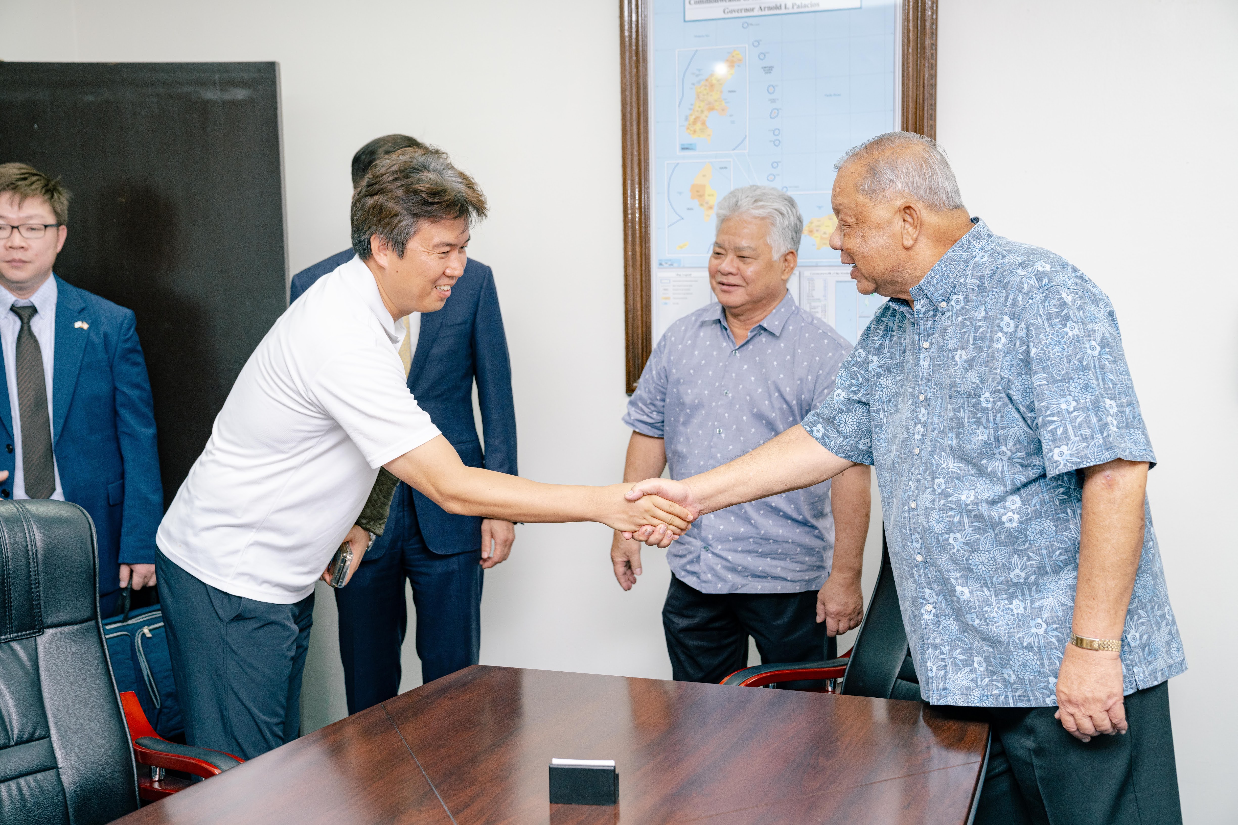 Lt. Gov. David M. Apatang shakes hands with Kim Bo Chyul, Korean consular assistant based in the CNMI.