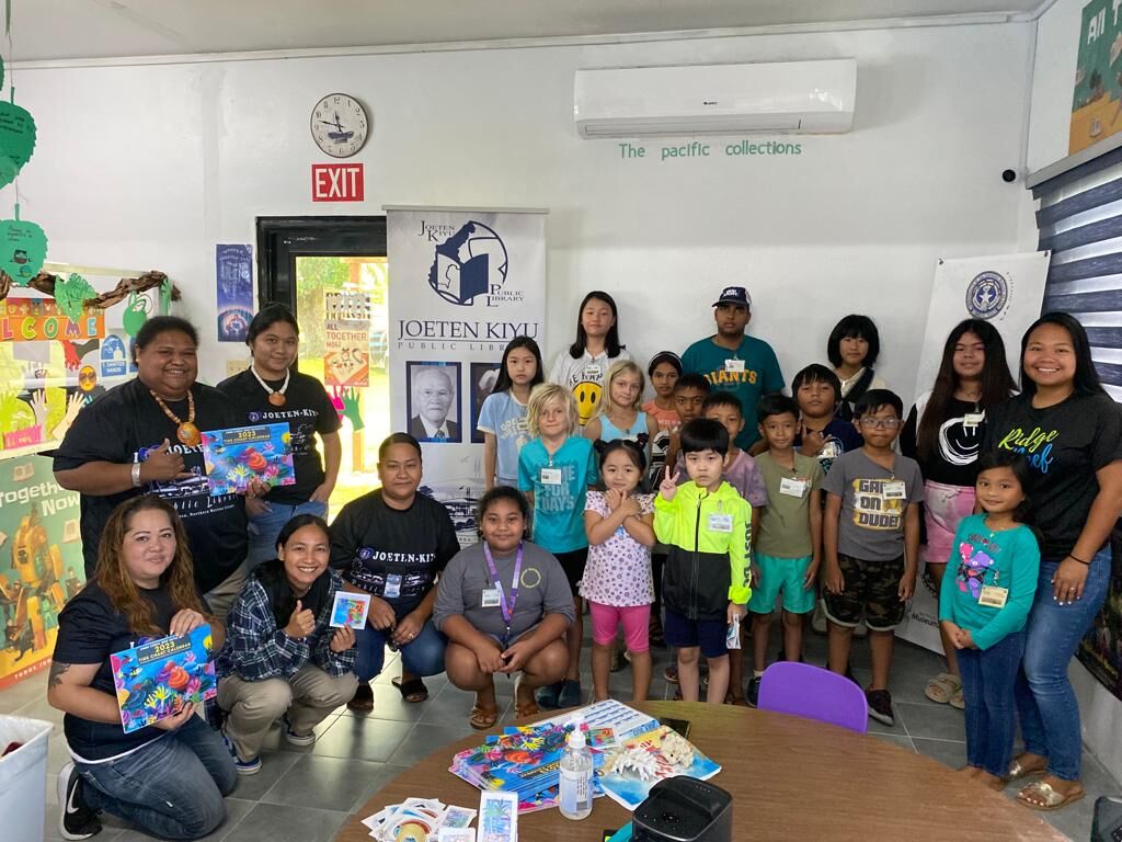 Students pose for a photo during a completion ceremony of the Bookmobile Outreach Summer Reading Program at the  San Antonio library.