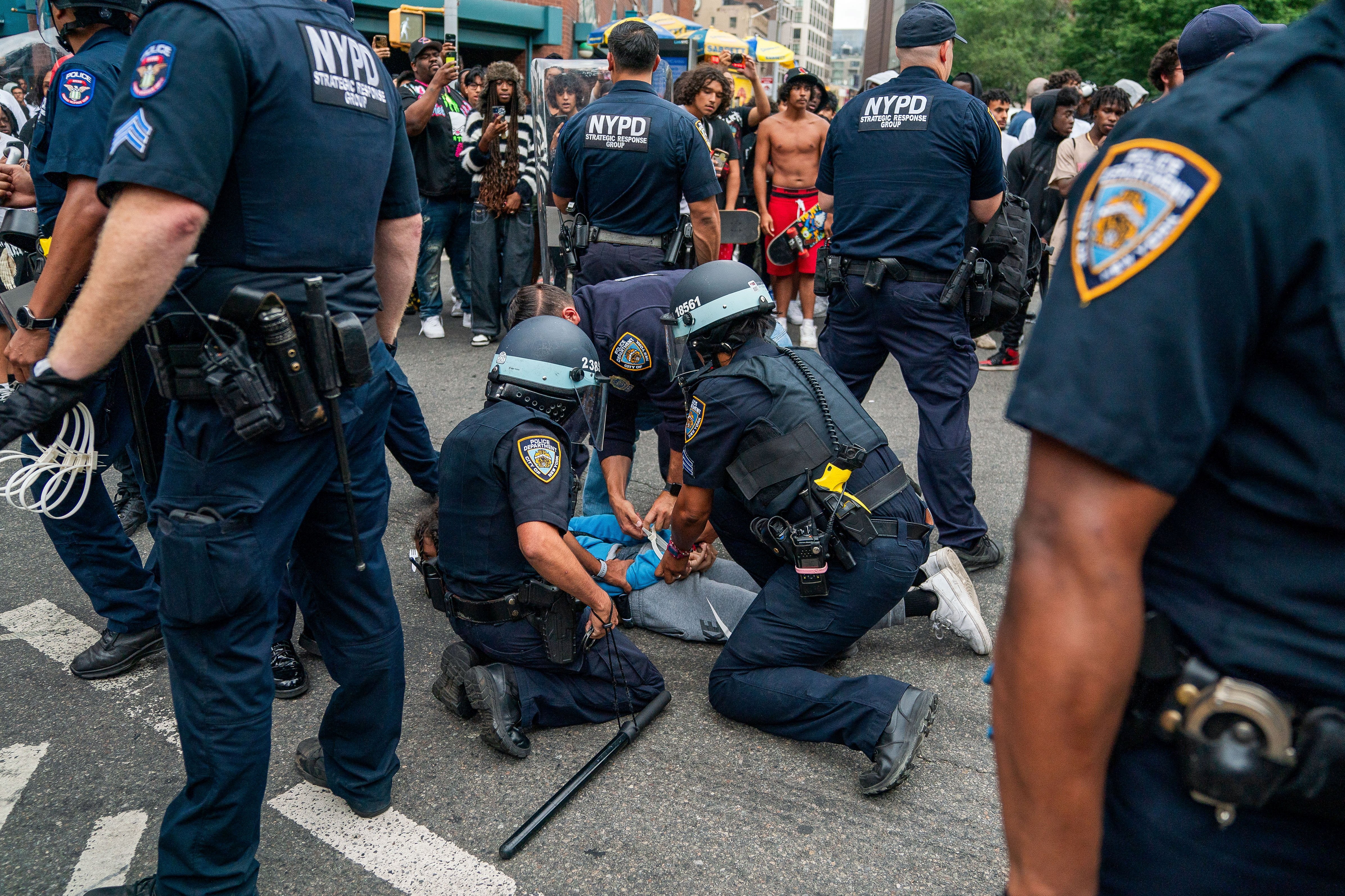 Police officers detain a person after popular live streamer Kai Cenat announced a "giveaway" event that grew chaotic, prompting police officers to respond and disperse the crowd at Union Square and the surrounding streets, in New York City, U.S. August 4, 2023. REUTERS/David 'Dee' Delgado
