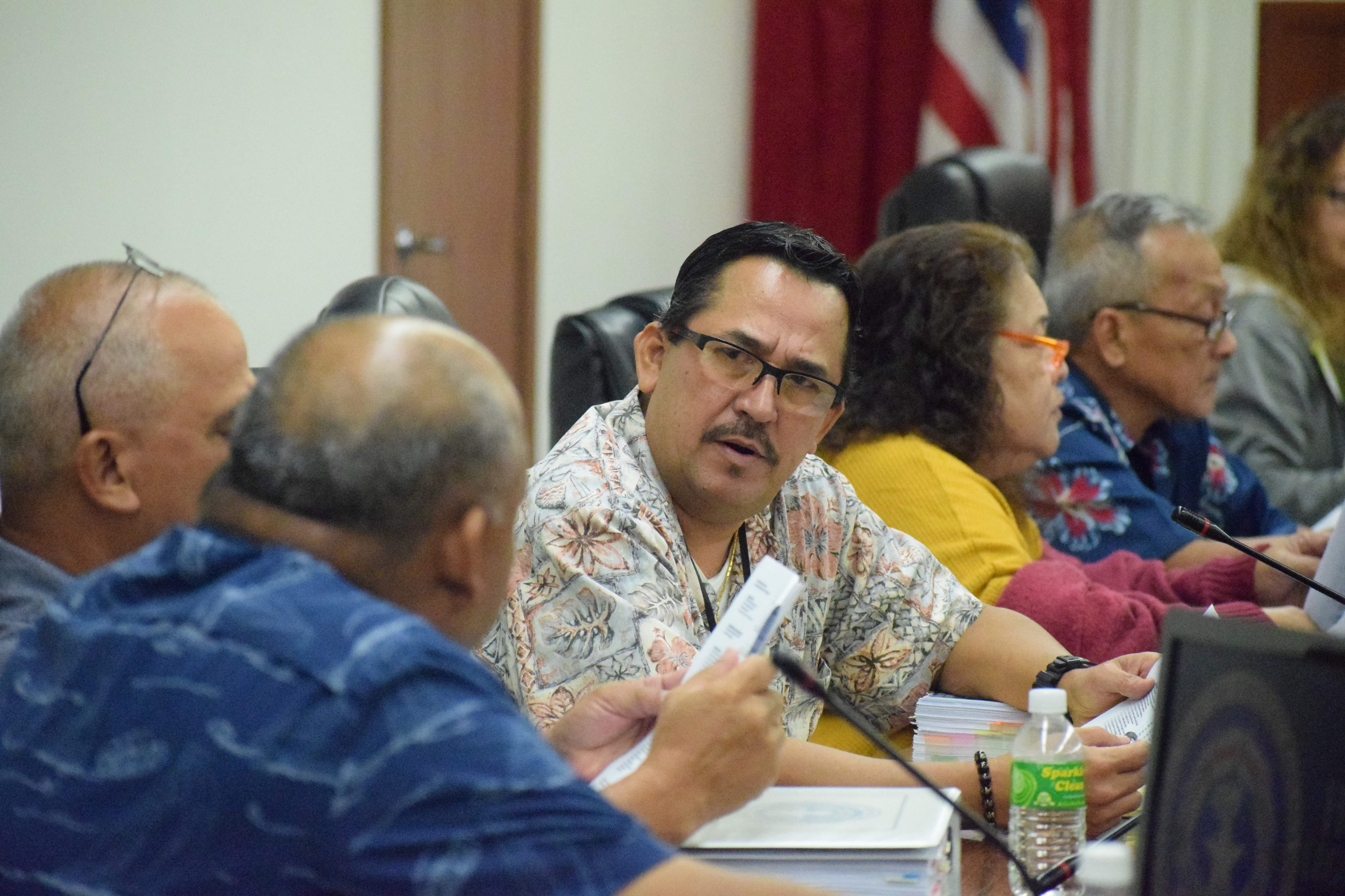 Rep. Patrick San Nicolas talks to Reps. John Paul Sablan and Joseph Flores during a recent House session.