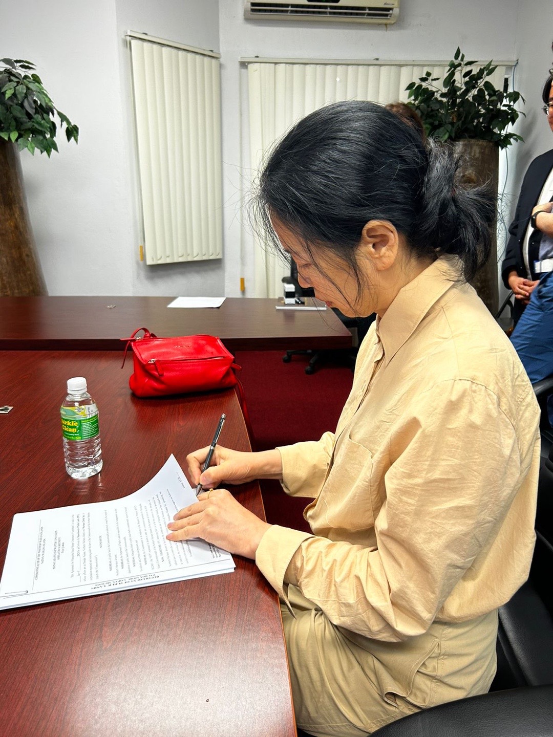 Younghee Yoon signs the master concessionaire agreement with the Department of Public Lands in July.