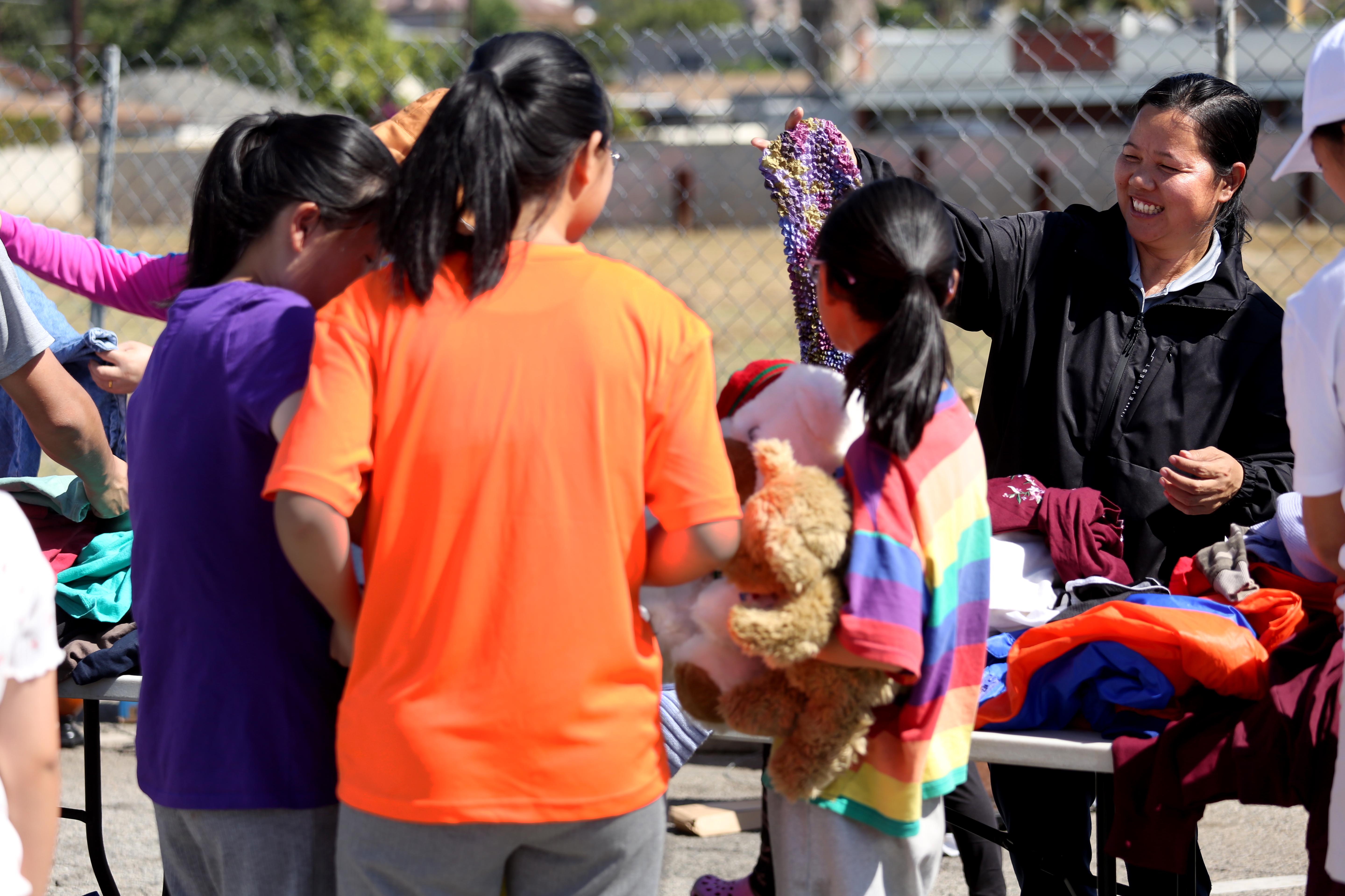 A woman who identified herself with the surname Dai, right, offers donated clothing to Chinese migrants at a giveaway event in Monterey Park in June. (Genaro Molina/Los Angeles Times/TNS) A woman who identified herself with the surname Dai, right, offers donated clothing to Chinese migrants at a giveaway event in Monterey Park in June. (Genaro Molina/Los Angeles Times/TNS)