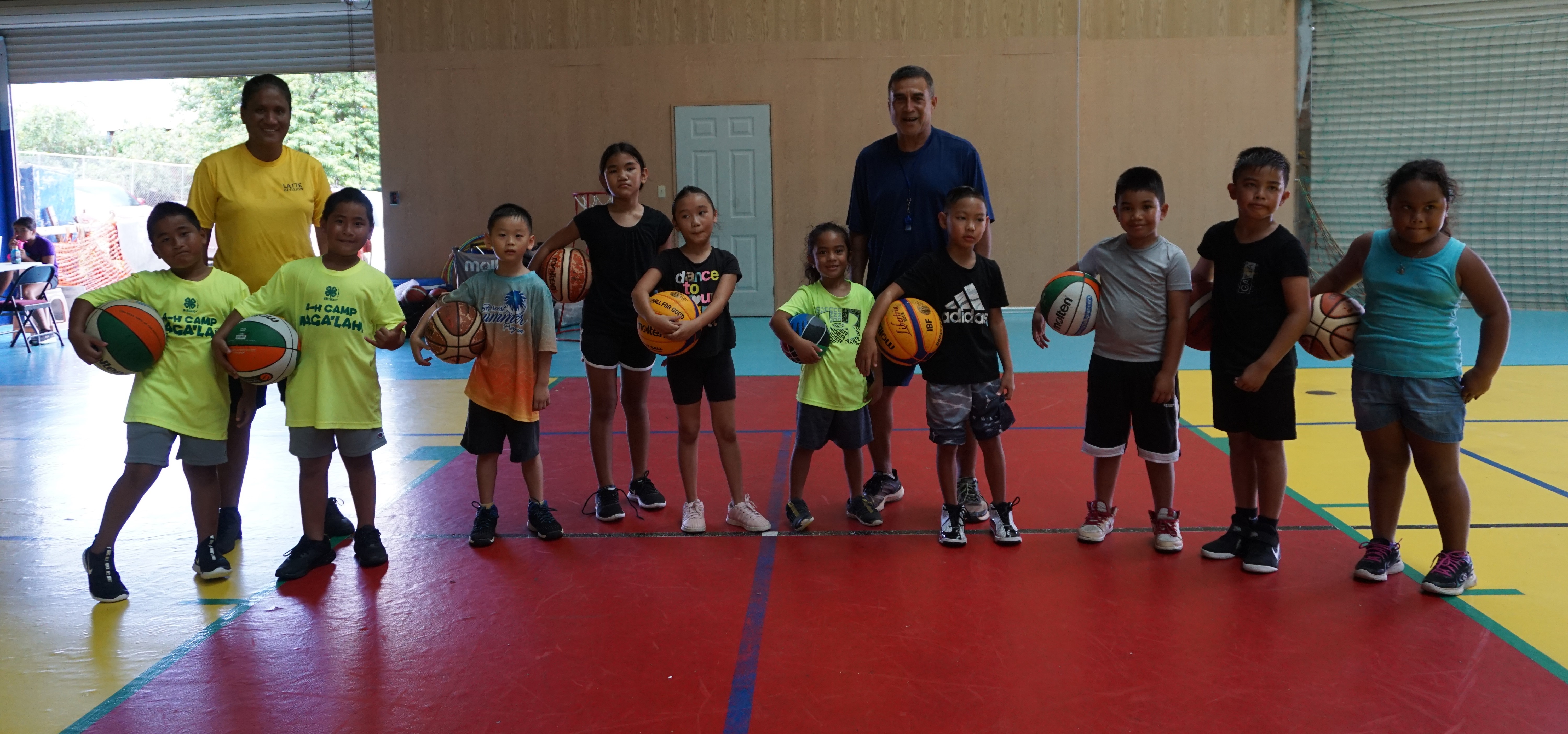 Elias Rangamar and Connie Camacho pose with the youth participants of the Taga Hoops program conducted by the Kultura Basketball Academy on Saturday at the Agape Christian School gym.