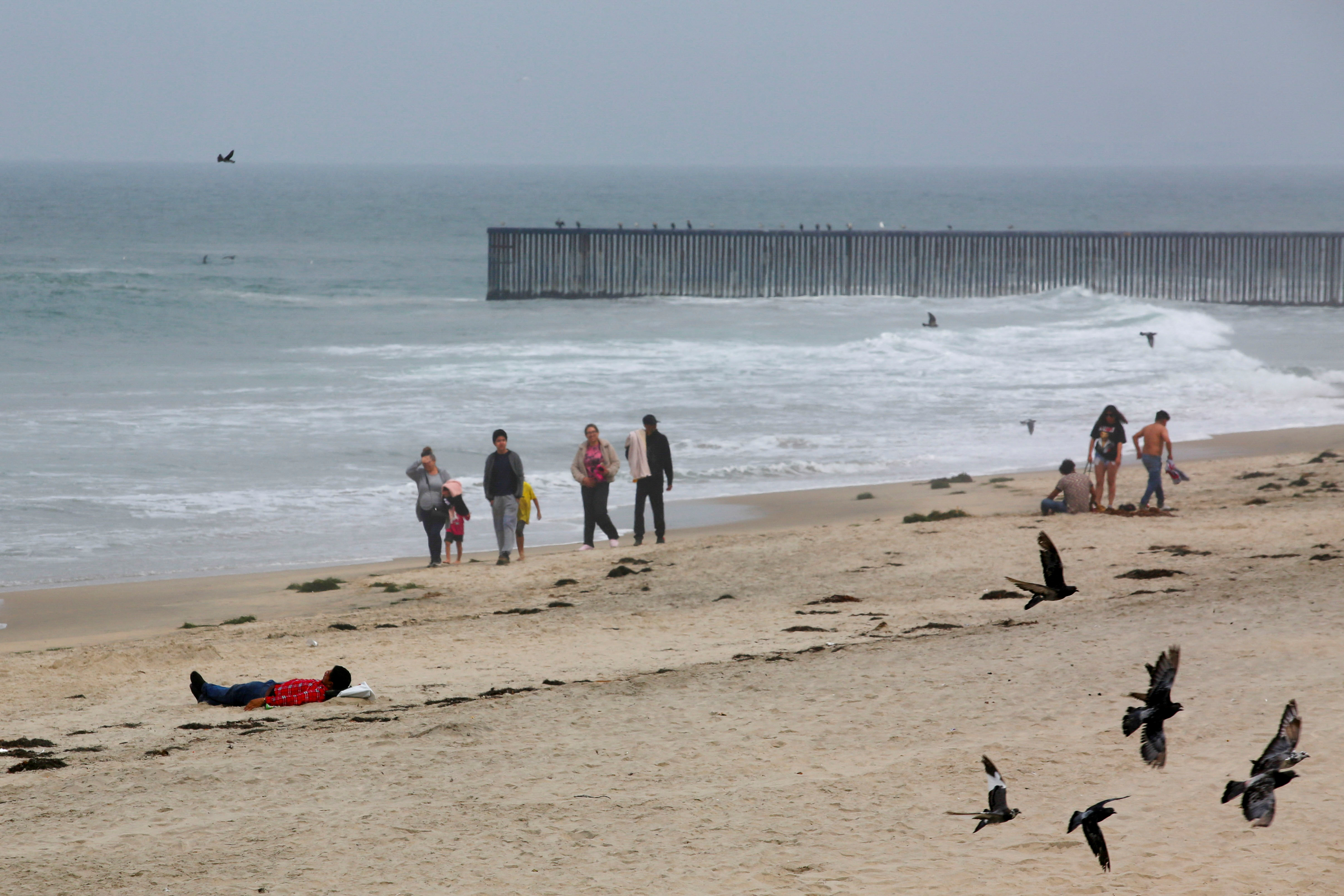 People walk at the beach as Hurricane Hilary hits Baja California state, in Tijuana, Mexico August 19, 2023. REUTERS/Jorge Duenes