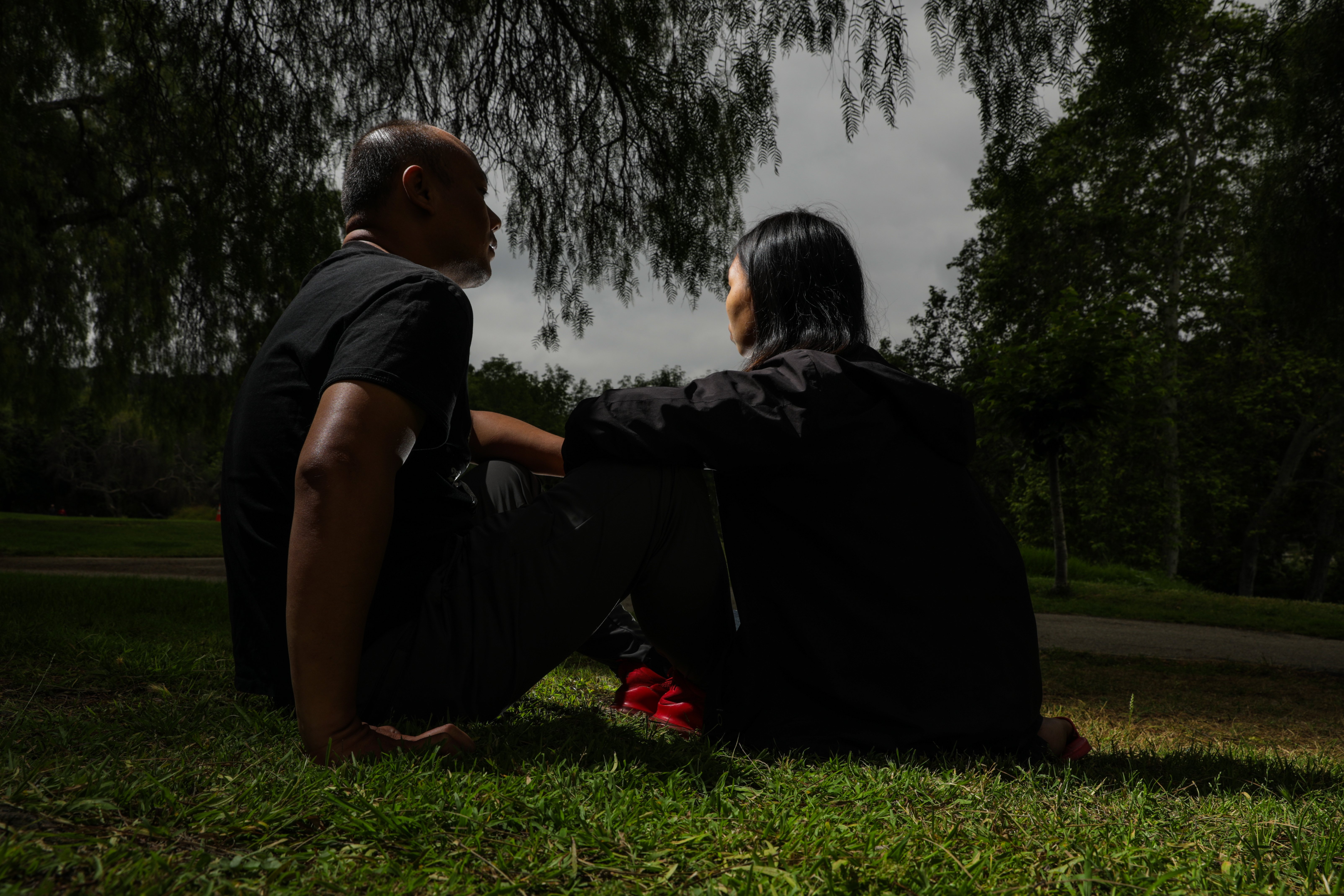 Shidong Liang, left, sitting with his wife at Peter F. Schabarum Regional Park, Rowland Heights in June, said he risked the perilous journey from China to the U.S. so his three children “can be independent. And when they grow up, to be able to have their own thoughts.” (Irfan Khan/Los Angeles Times/TNS)