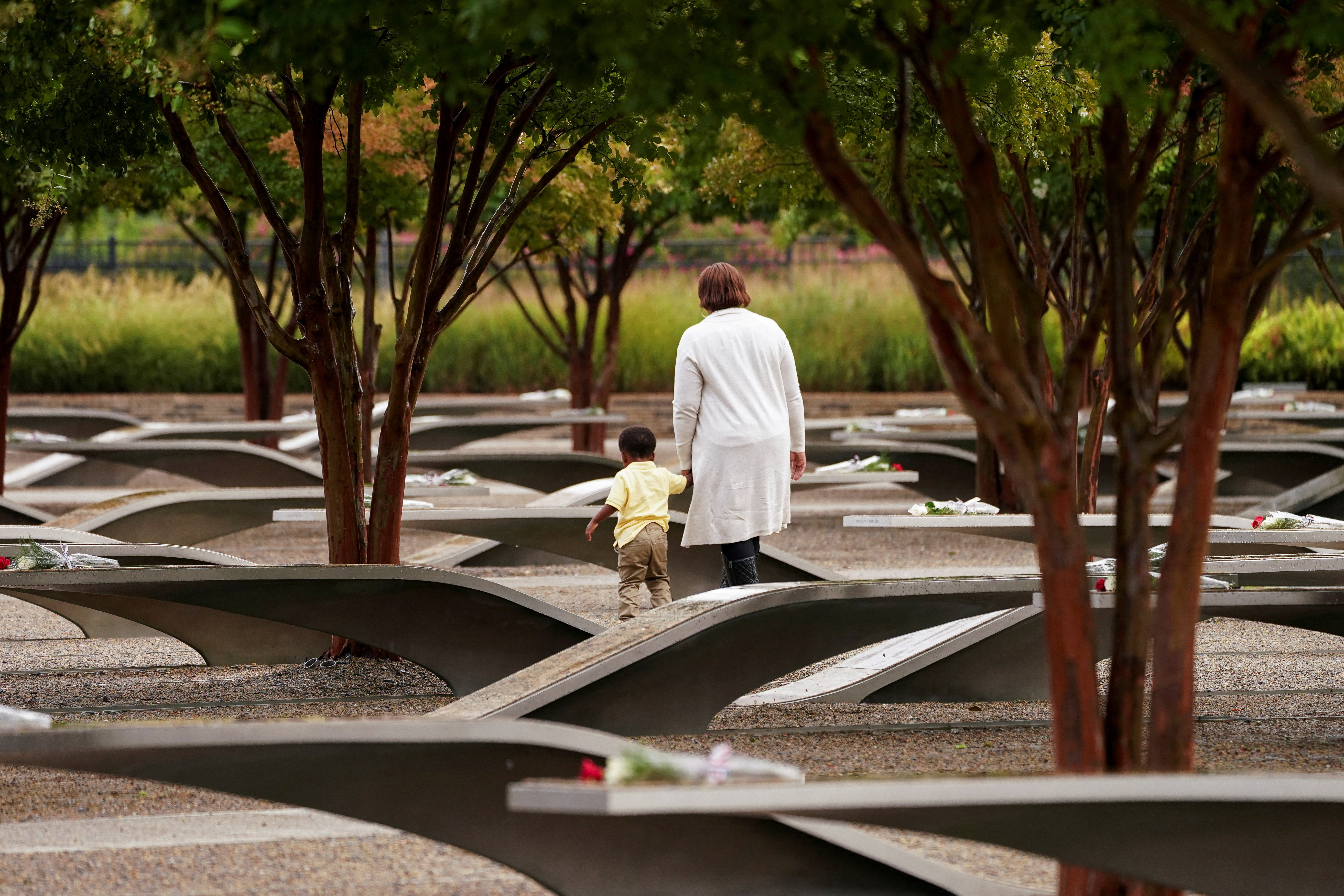 Family members of a victim visit the Pentagon Memorial on the 22nd anniversary of September 11, 2001 attacks, in Washington, U.S., September 11, 2023. 