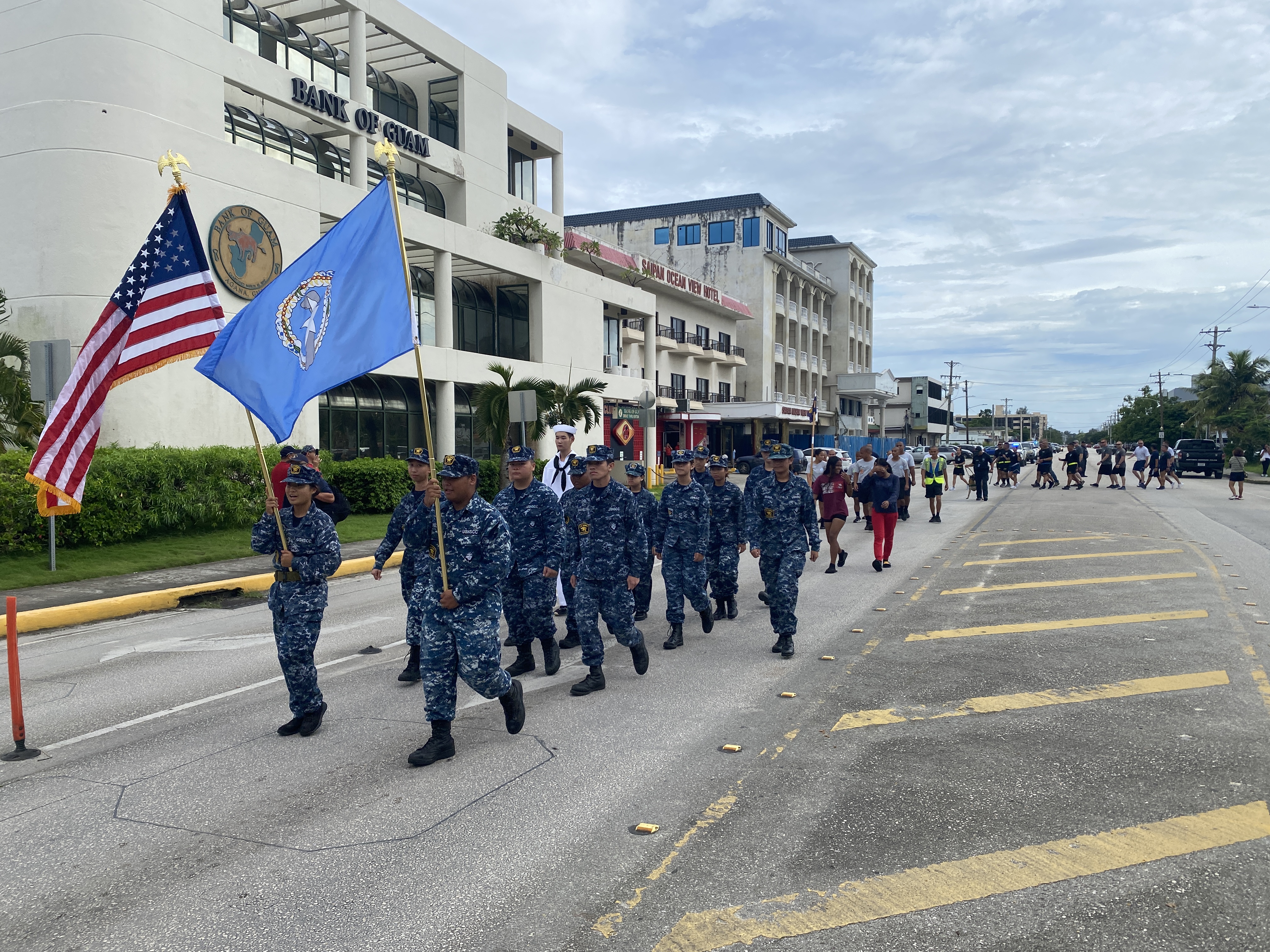 Sea Cadets march with first responders and fire and emergency services personnel.