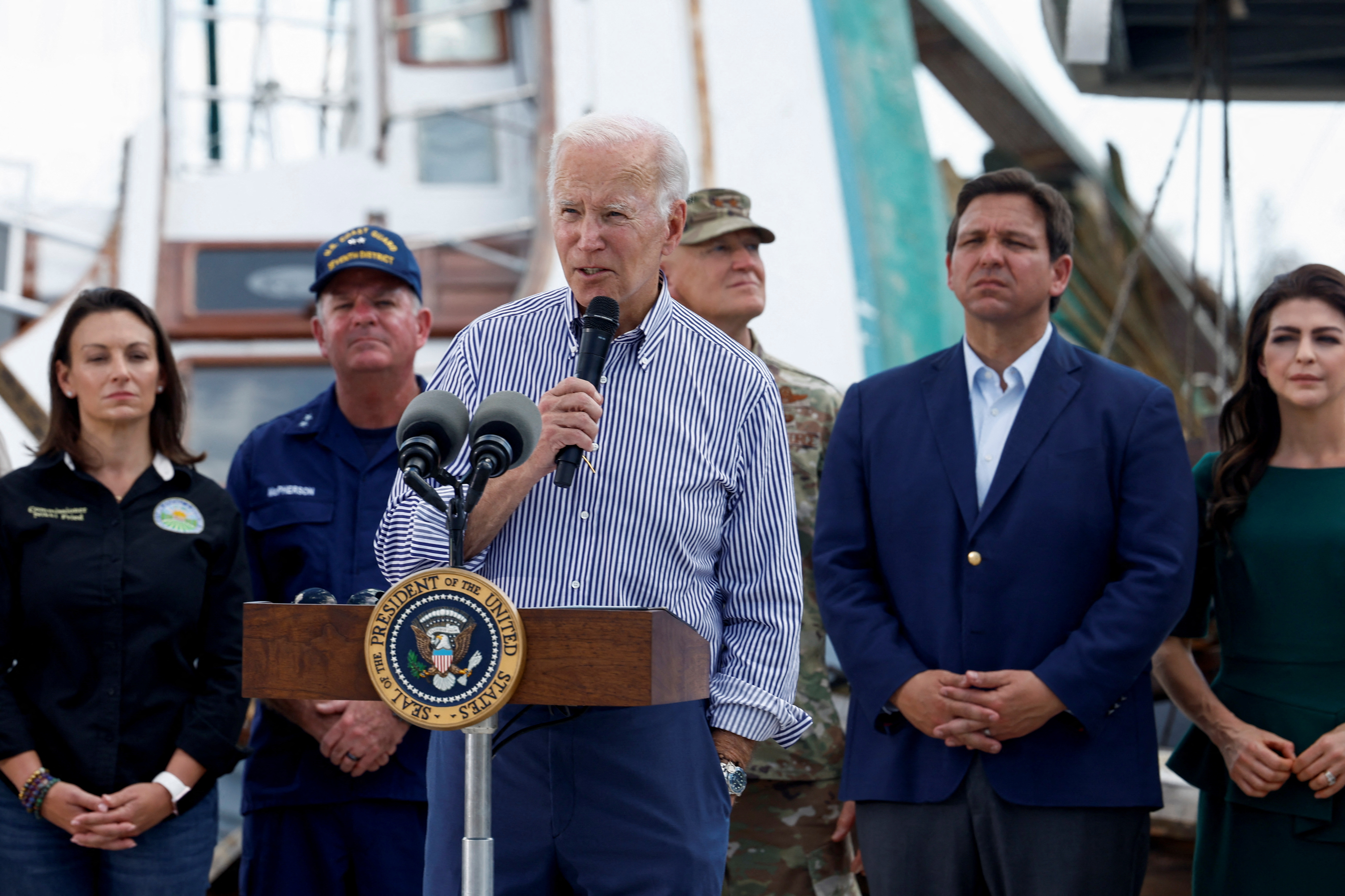 U.S. President Joe Biden speaks about the destruction caused by Hurricane Ian and relief efforts as he visits Fisherman's Wharf while touring hurricane-damaged areas, joined by first lady Jill Biden, Florida Governor Ron DeSantis and his wife Casey DeSantis, in Fort Myers Beach, Florida, U.S., October 5, 2022. REUTERS/Evelyn Hockstein