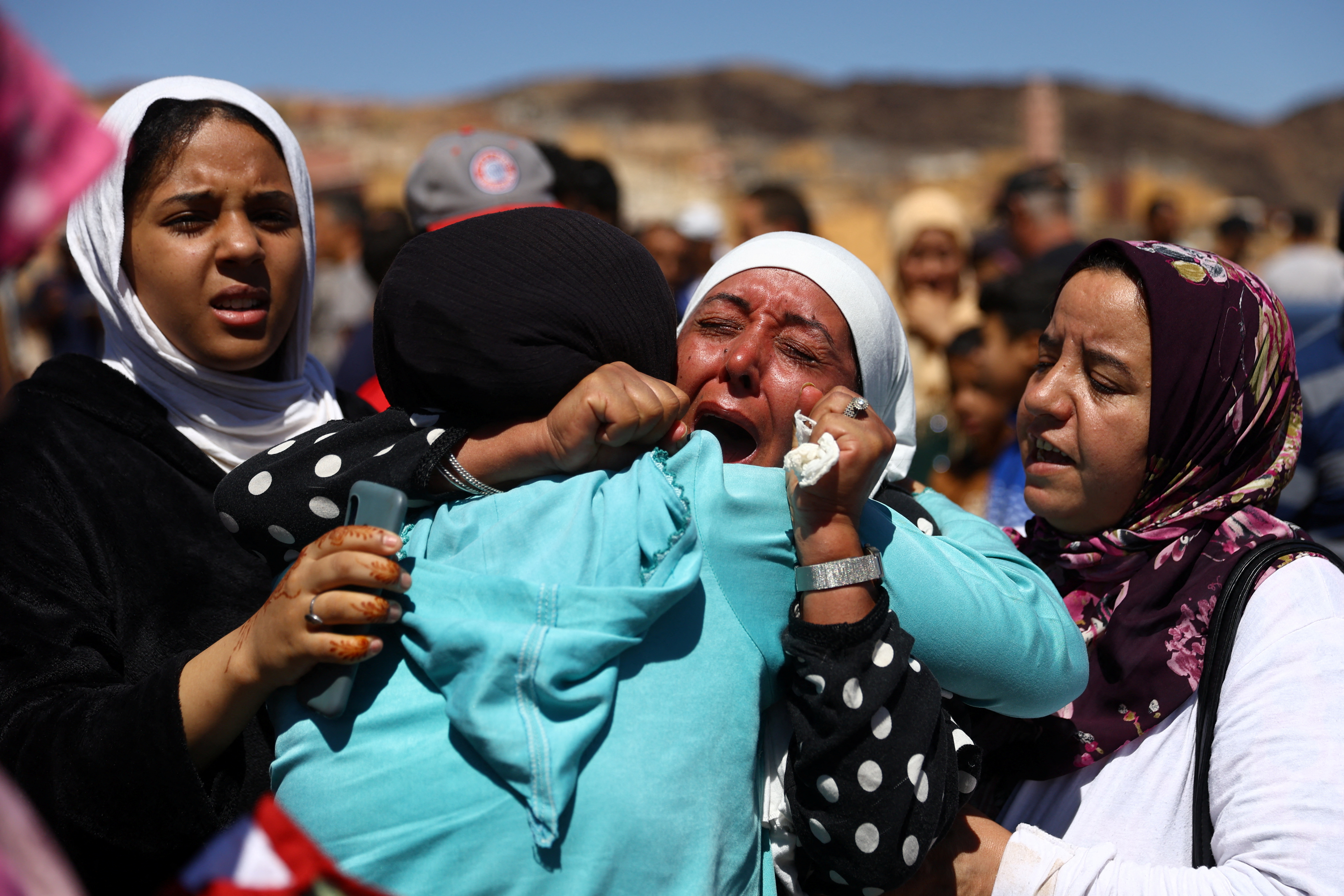 People react during the funeral of two victims of the deadly earthquake, in Moulay Brahim, Morocco, September 10, 2023. REUTERS/Hannah McKay