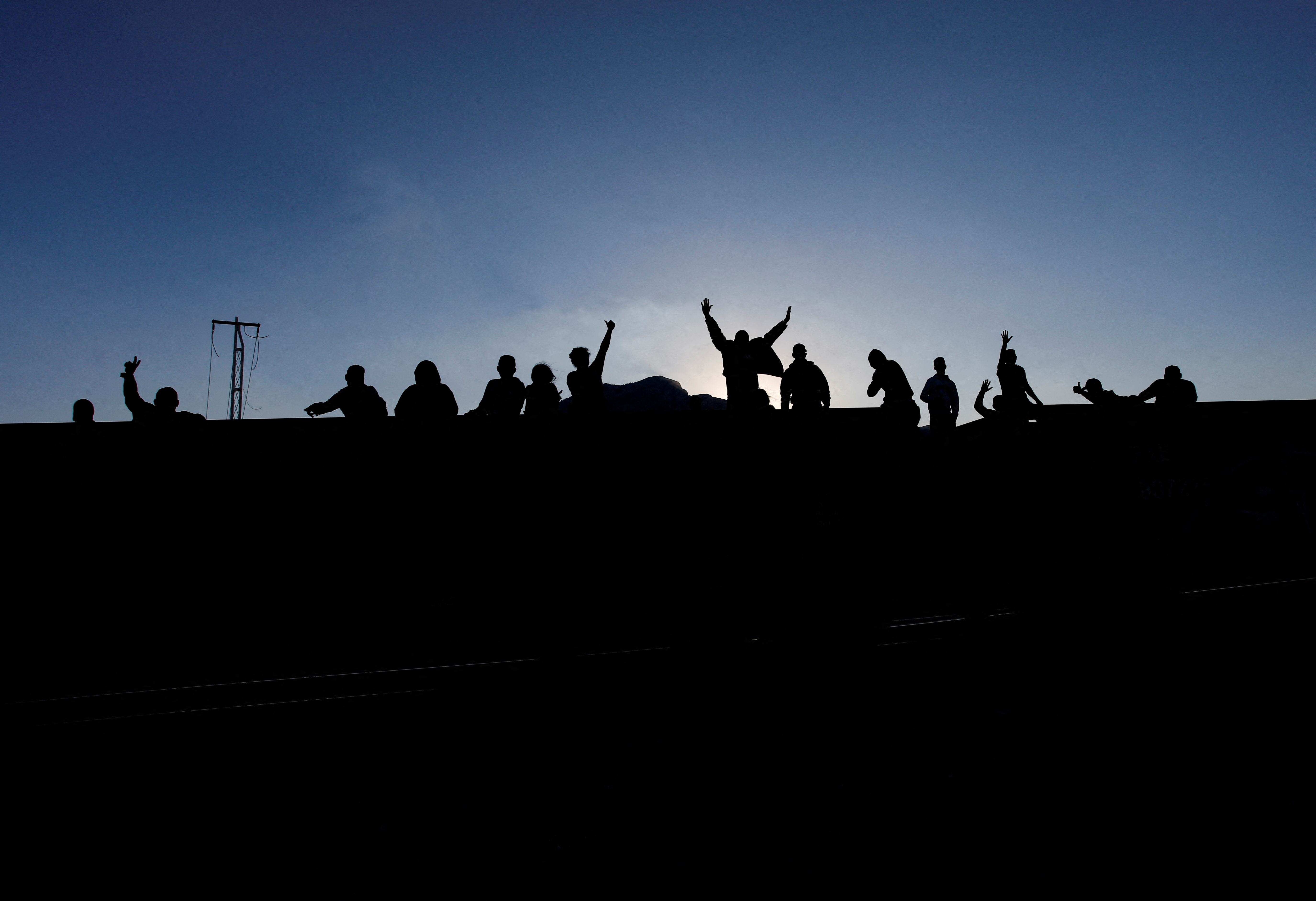 Asylum seekers heading to the U.S. travel on a train after thousands of migrants crossed into the United States in recent days, in El Carmen, Mexico September 21, 2023. 