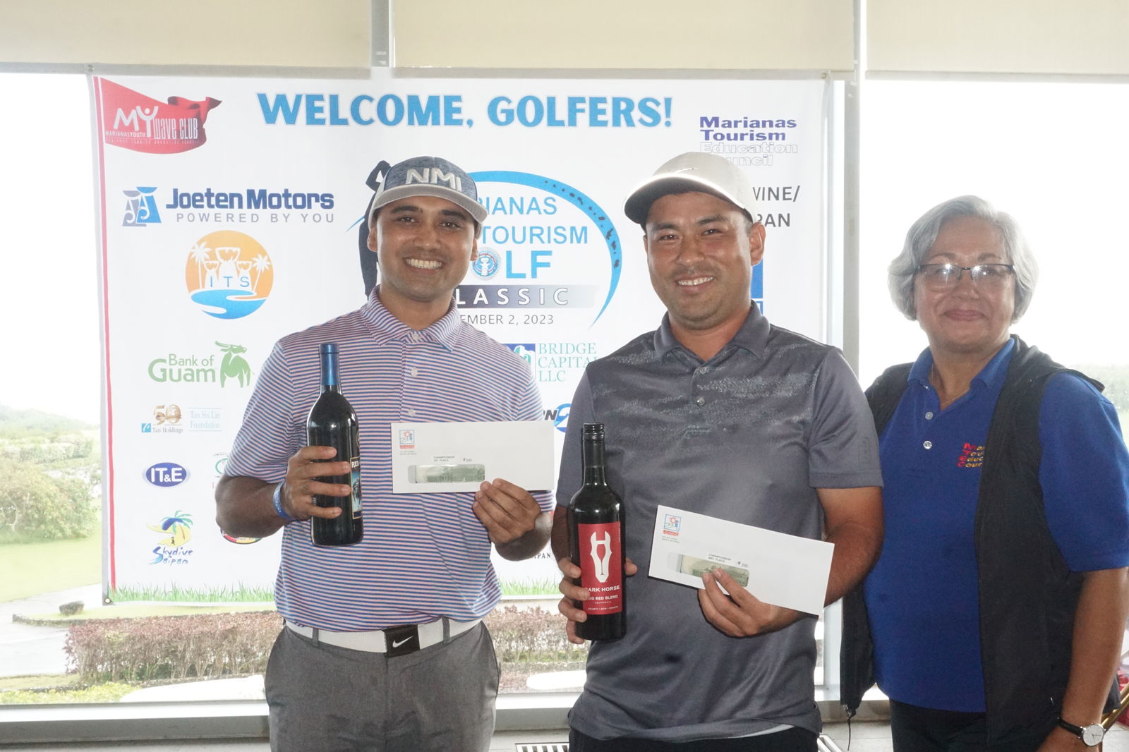 Tournament winner Franco Santos and John Josph Muna, who placed third, pose with Marianas Tourism Education Council Chair Vicky Benavente following the 2023 Marianas Tourism Golf Classic on Saturday at the LaoLao Bay Golf & Resort west course. 