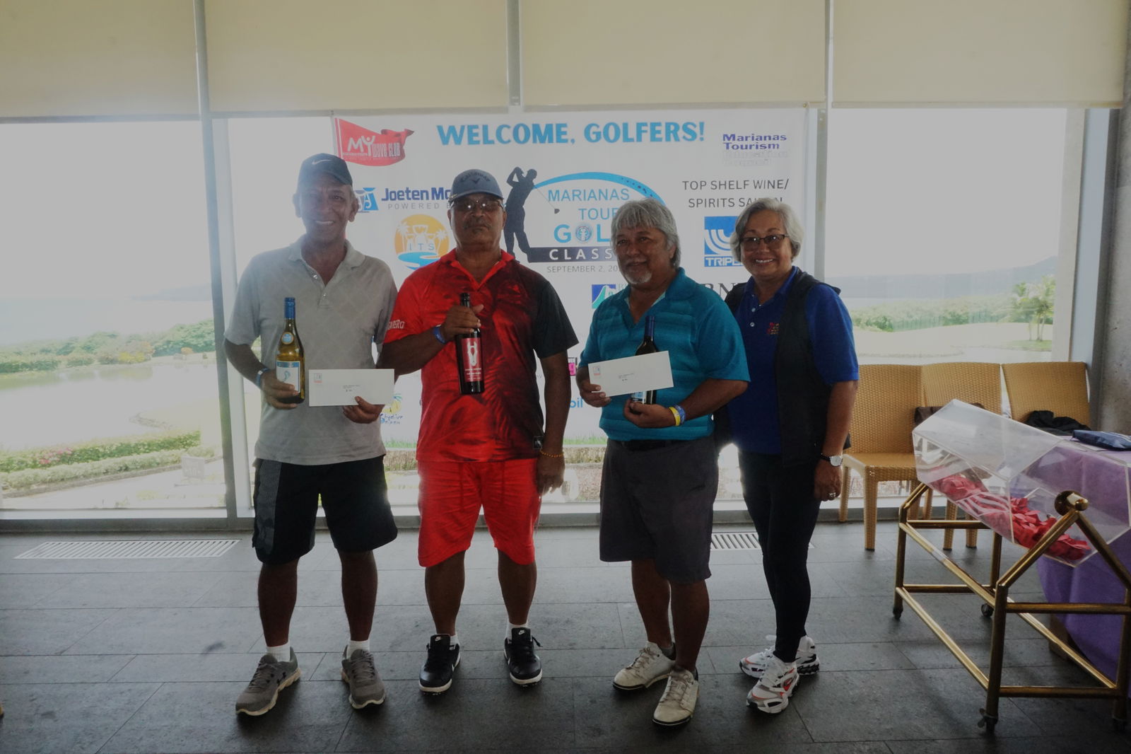 The top three players of the Super Senior flight — Manny Mangarero, Richard Sablan and Joe Sablan Jr. — pose for a photo with Marianas Tourism Education Council Chair Vicky Benavente during the awards ceremony of the 2023 Marianas Tourism Golf Classic on Saturday at the LaoLao Bay Golf & Resort west course.