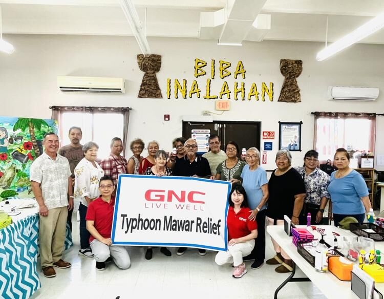 Del. James Moylan, left, and GNC employees visited residents at the senior center in Inalåhan Sept. 5. 