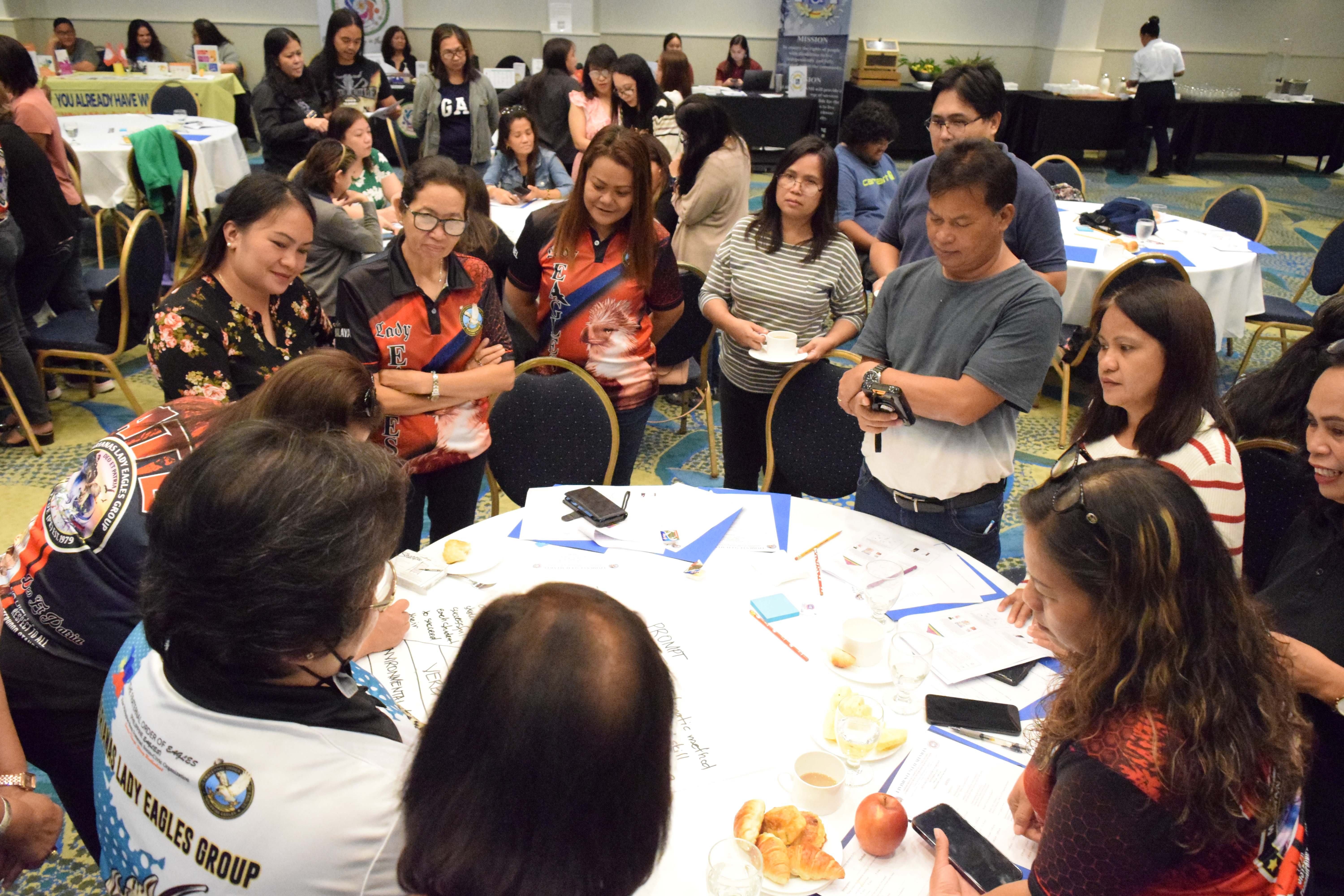 Parents participate in a round-table group discussion.