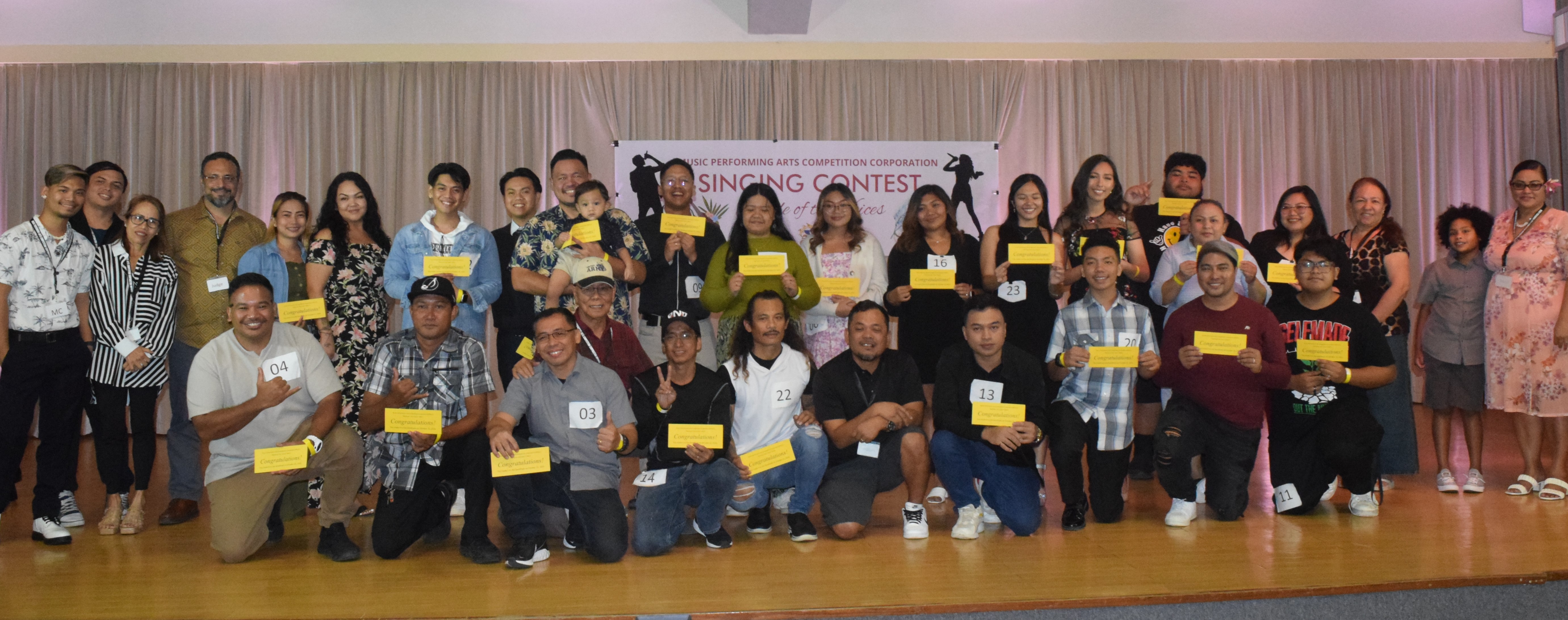 The contestants who made it to the next round of the Battle of the Voices pose for a photo with the judges and Music Performing Arts Competition Corp. officers at the Gov. Pedro P. Tenorio Multi-Purpose Center on Saturday.