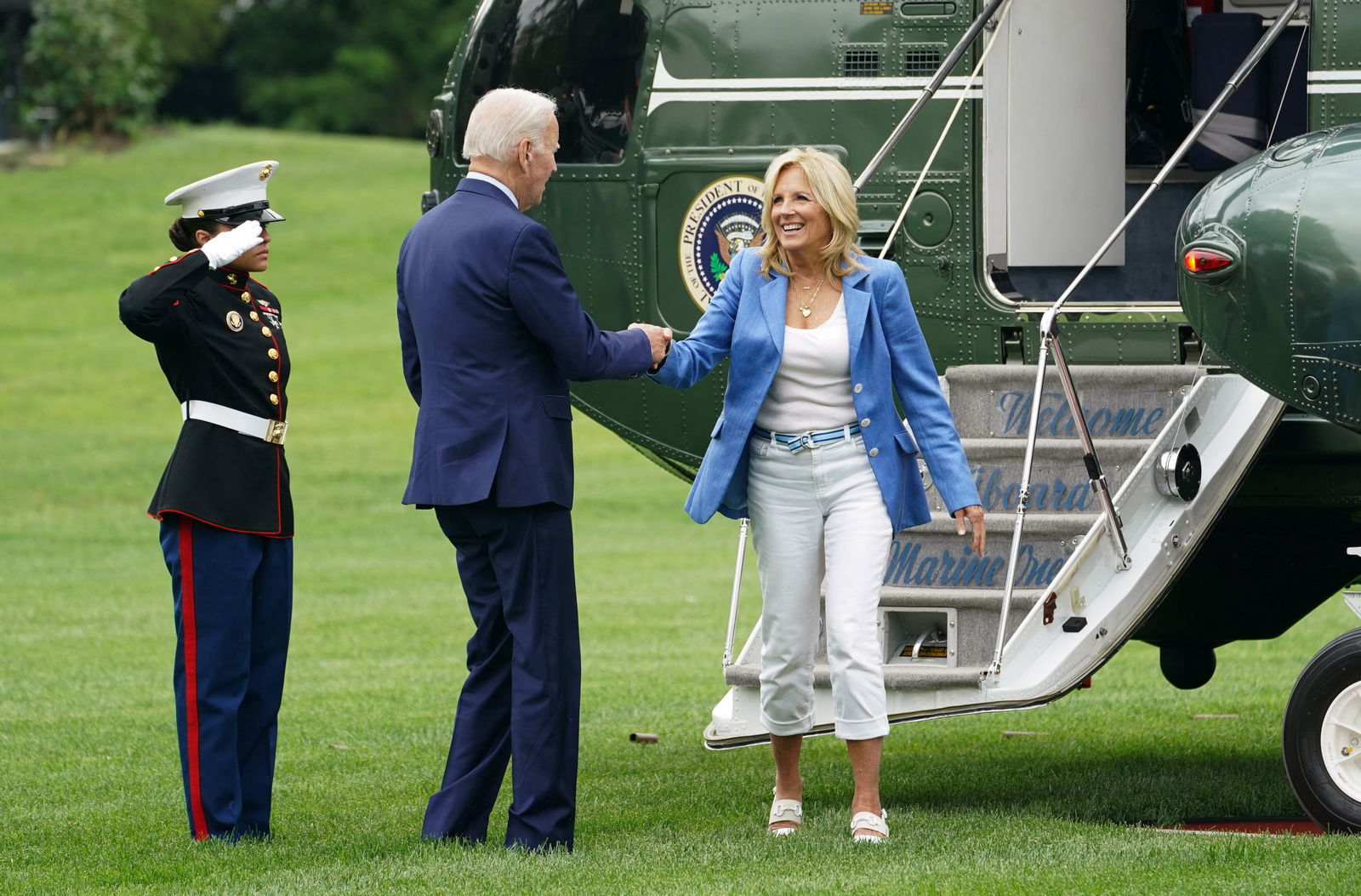 U.S. President Joe Biden assists first lady Jill Biden as they step from Marine One upon their return from Delaware to the White House in Washington, U.S., August 7, 2023. REUTERS/Kevin Lamarque/File Photo