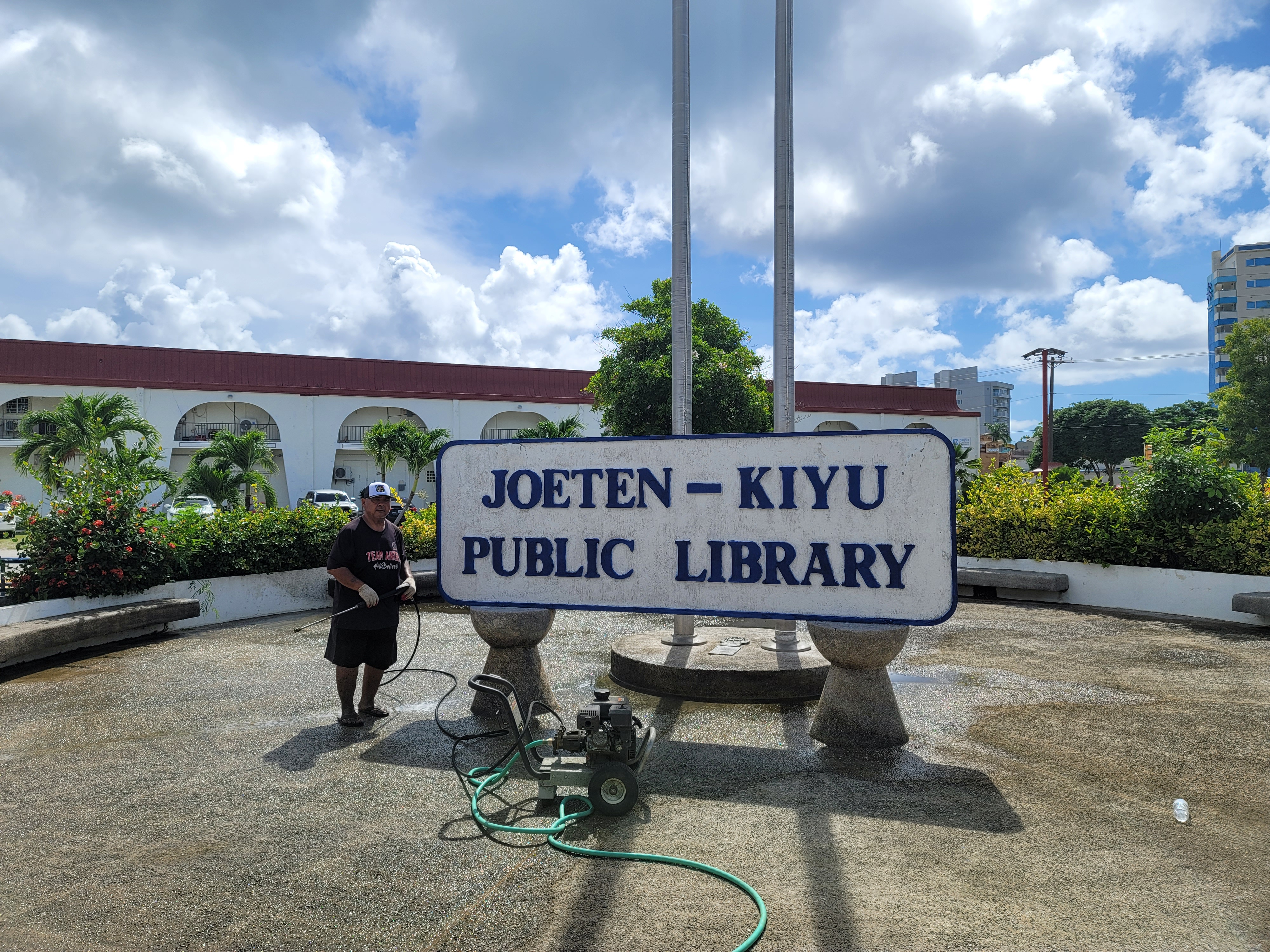 Juan C. Lizama from the office of Rep. John Paul Sablan used a water blaster to clean up the JKPL courtyard.