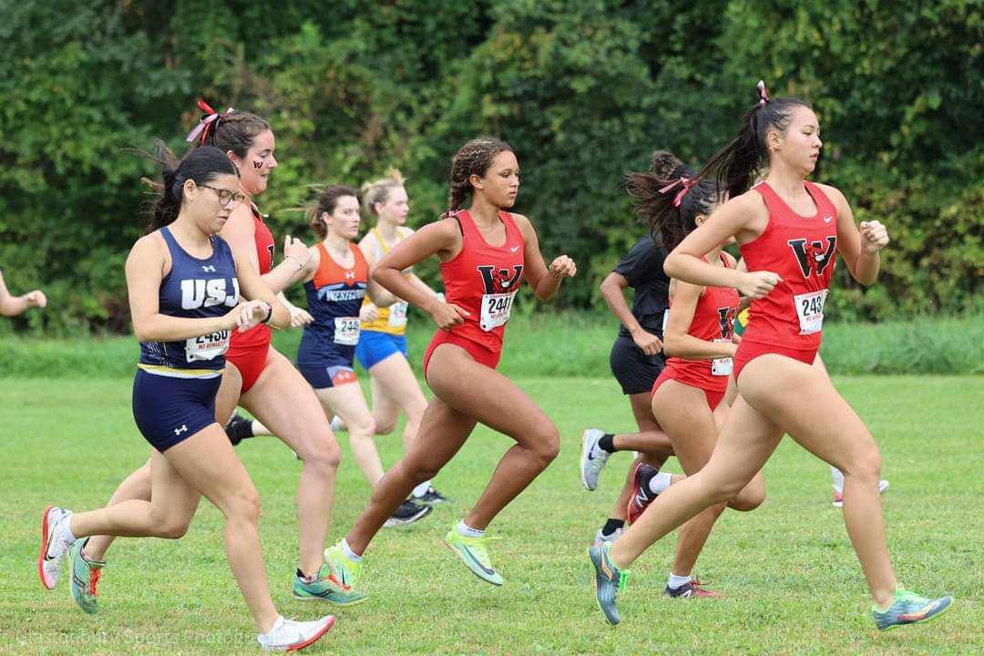Tiana Cabrera, right, leads a group of runners during the Wesleyan Cardinal Invitational cross country race on Saturday in Middletown, Connecticut.