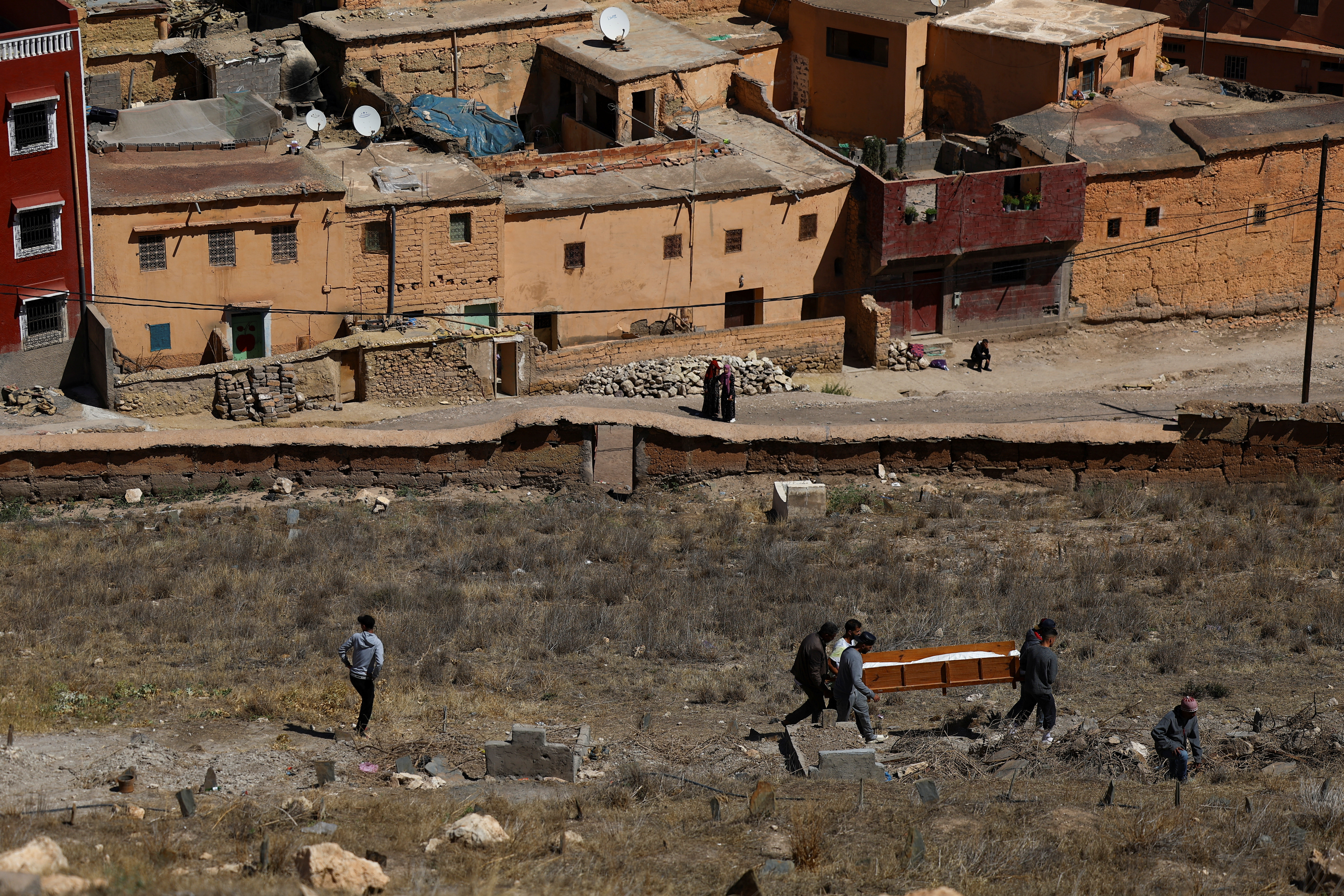 People attend the funeral of two victims of the deadly earthquake, in Moulay Brahim, Morocco, September 10, 2023. REUTERS/Hannah McKay