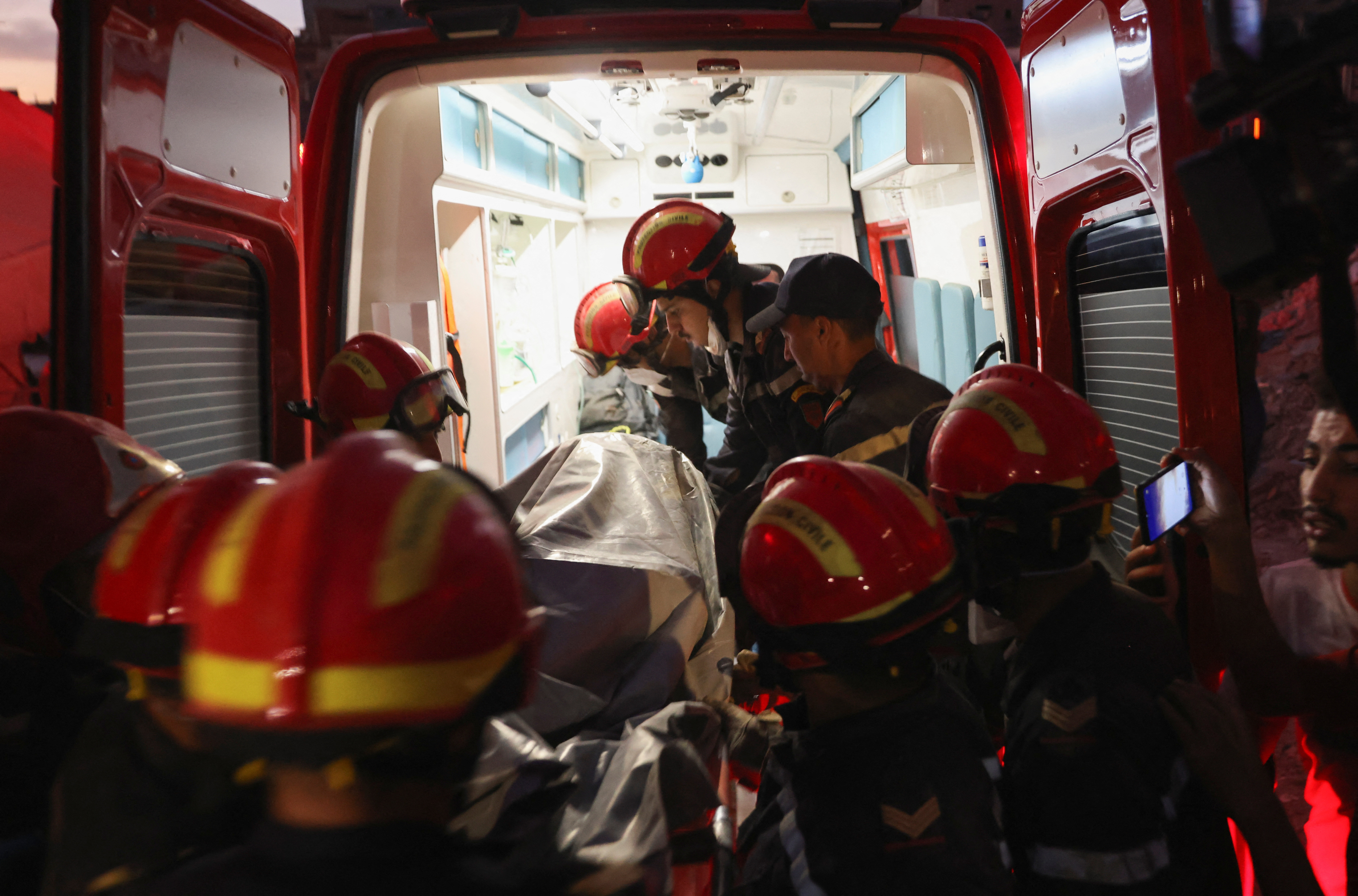Emergency crews place a body to a vehicle, in the aftermath of a deadly earthquake, in Amizmiz, Morocco, September 10, 2023. REUTERS/Nacho Doce