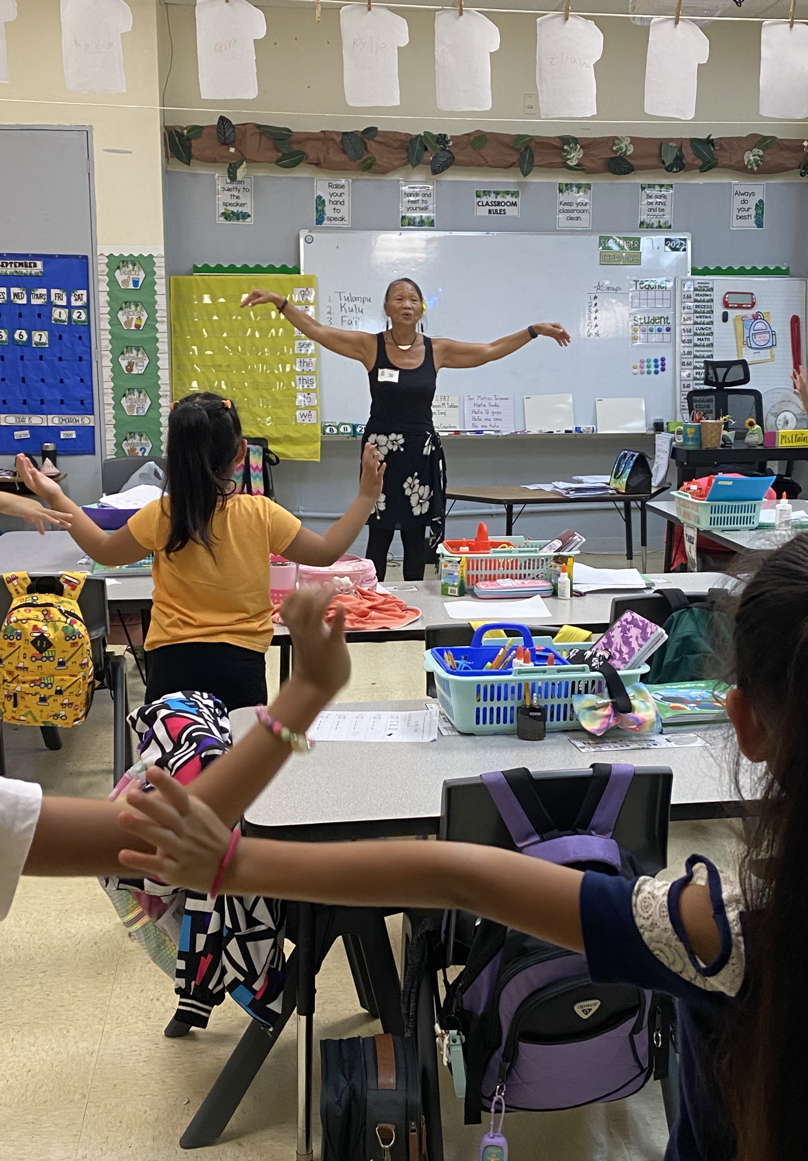 Frances Sablan teaches school children how to chant and dance Fa'i.