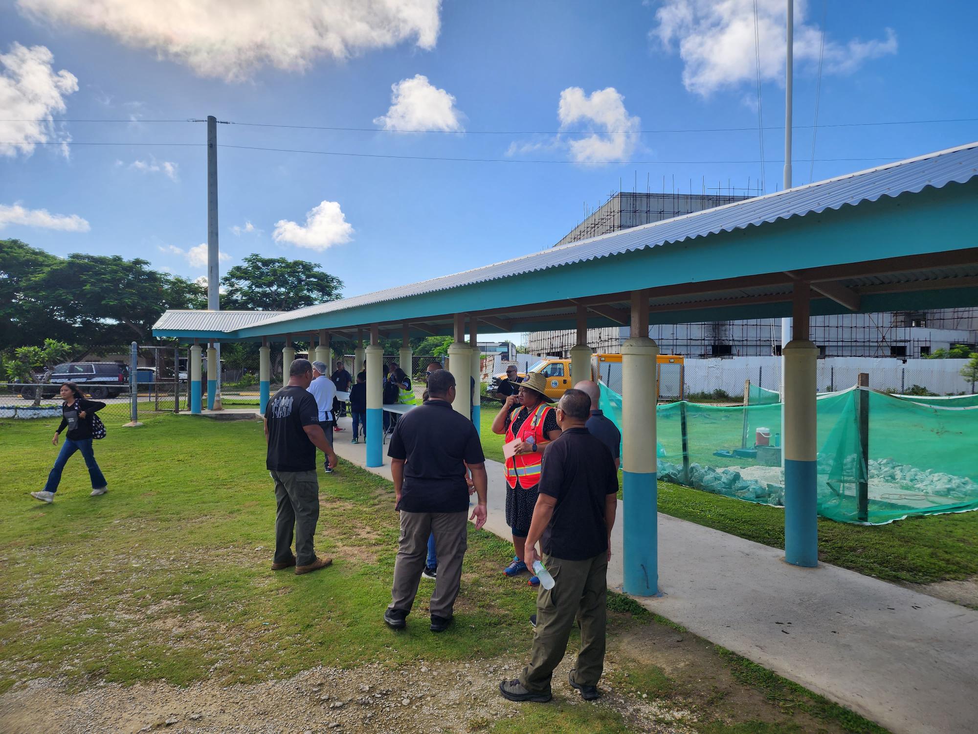 DPS-Criminal Investigation Division investigators, an FBI agent, FMSMS school Principal Cherlyn Osung and acting Vice Principal Cathy Aseras-Cabrera — partly hidden — confer on Thursday morning.