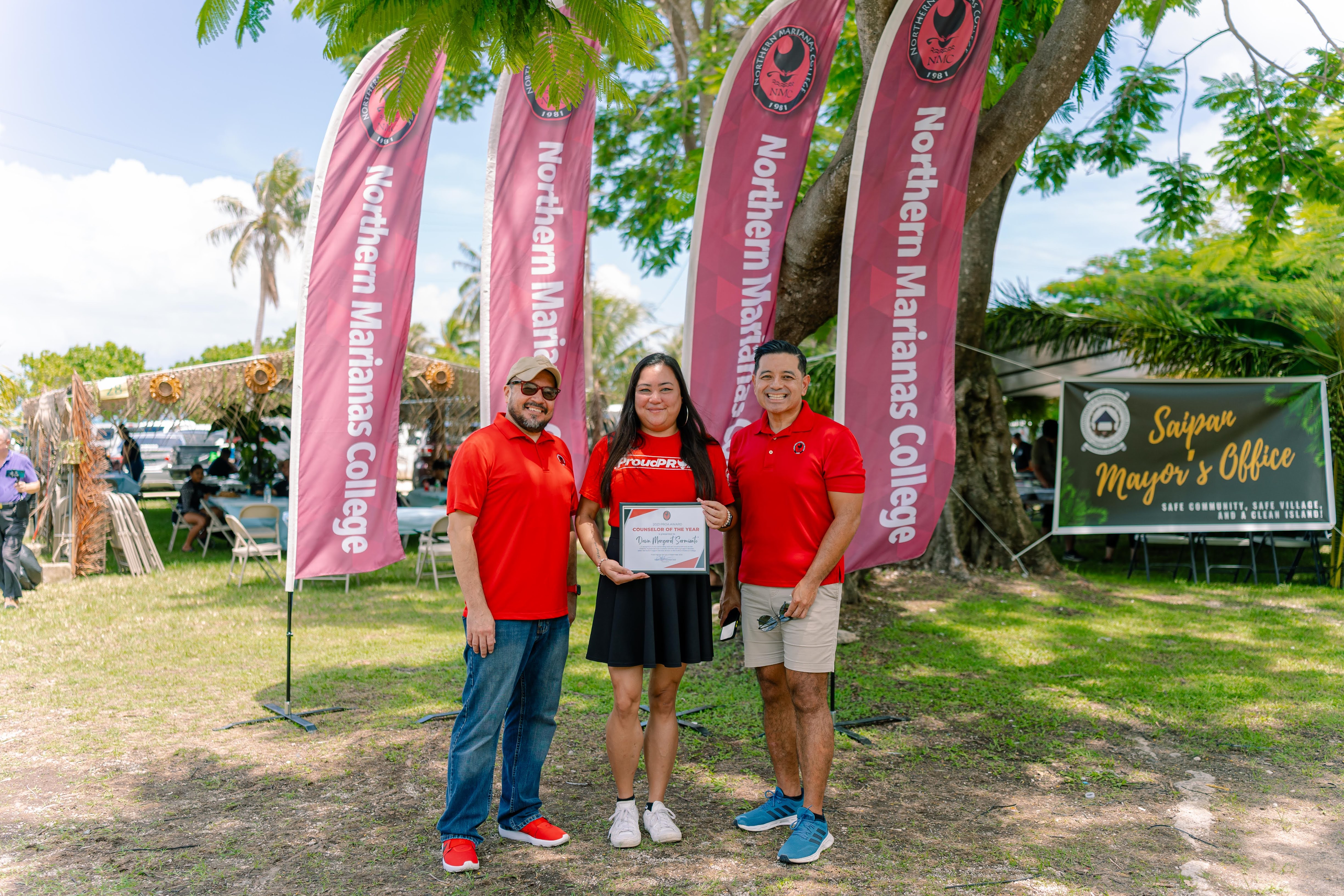 Counselor of the Year and Disability Support Services Counselor Dawn Margaret Sarmiento, center, with NMC President Galvin Deleon Guerrero, EdD, left, and NMC Vice President for Administration and Advancement Frankie Eliptico, right.